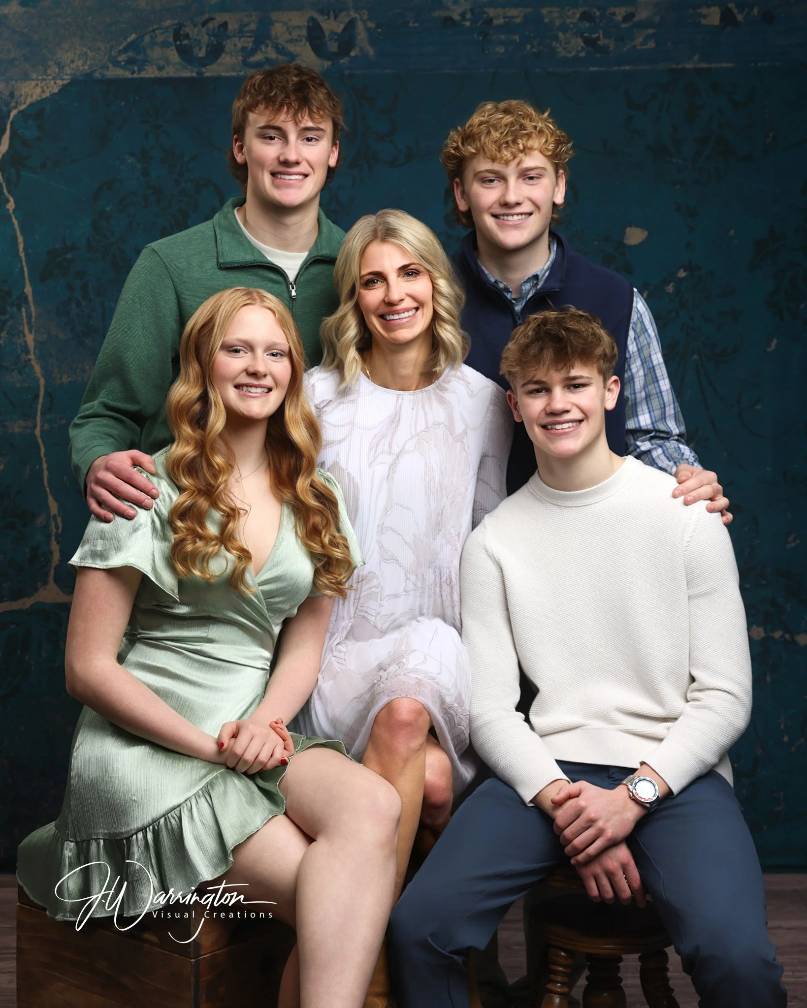 Professional studio family portrait featuring a smiling mother, daughter, and three teenage sons by a Northwest Ohio photographer 