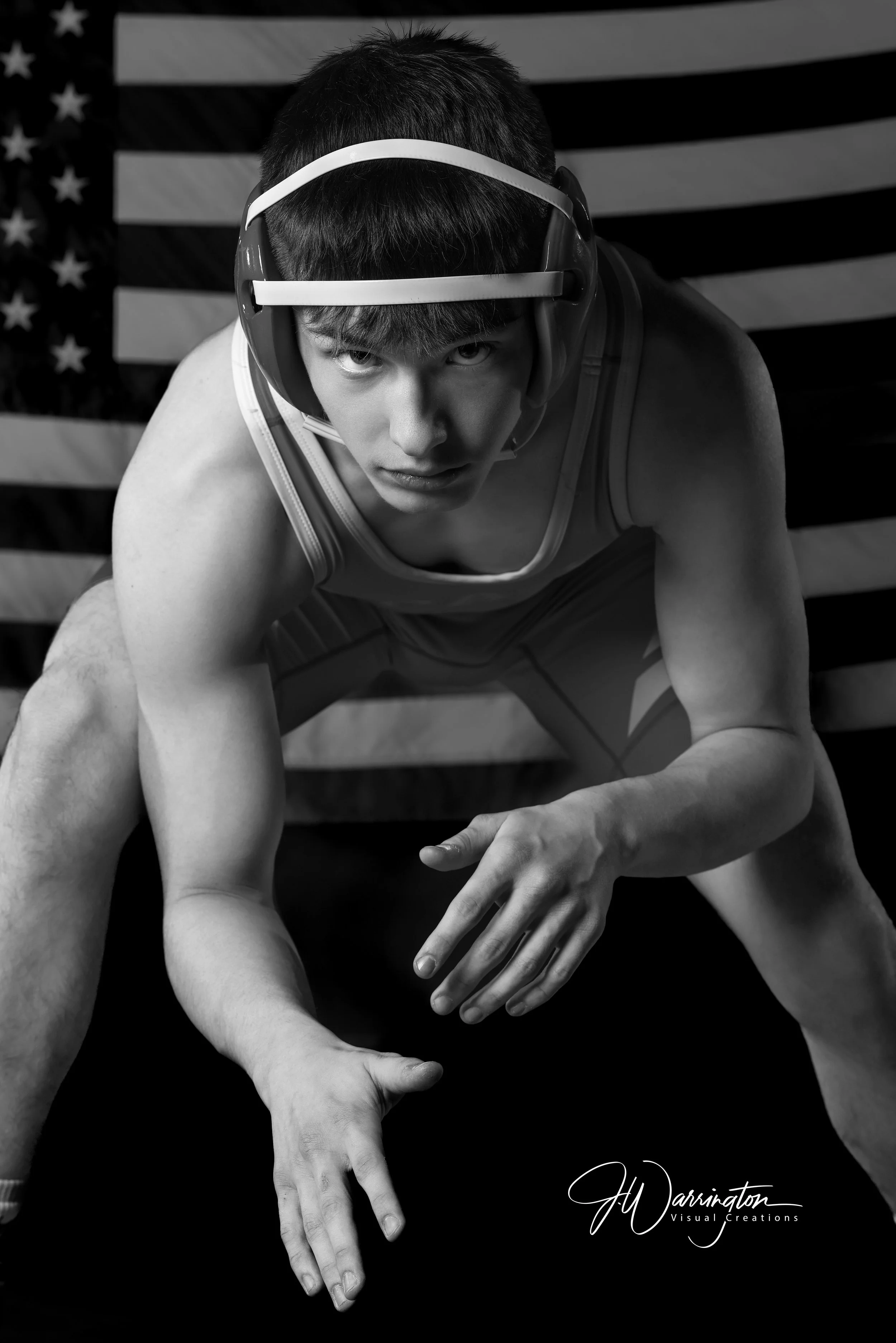 Wrestler in ready position in black and white.