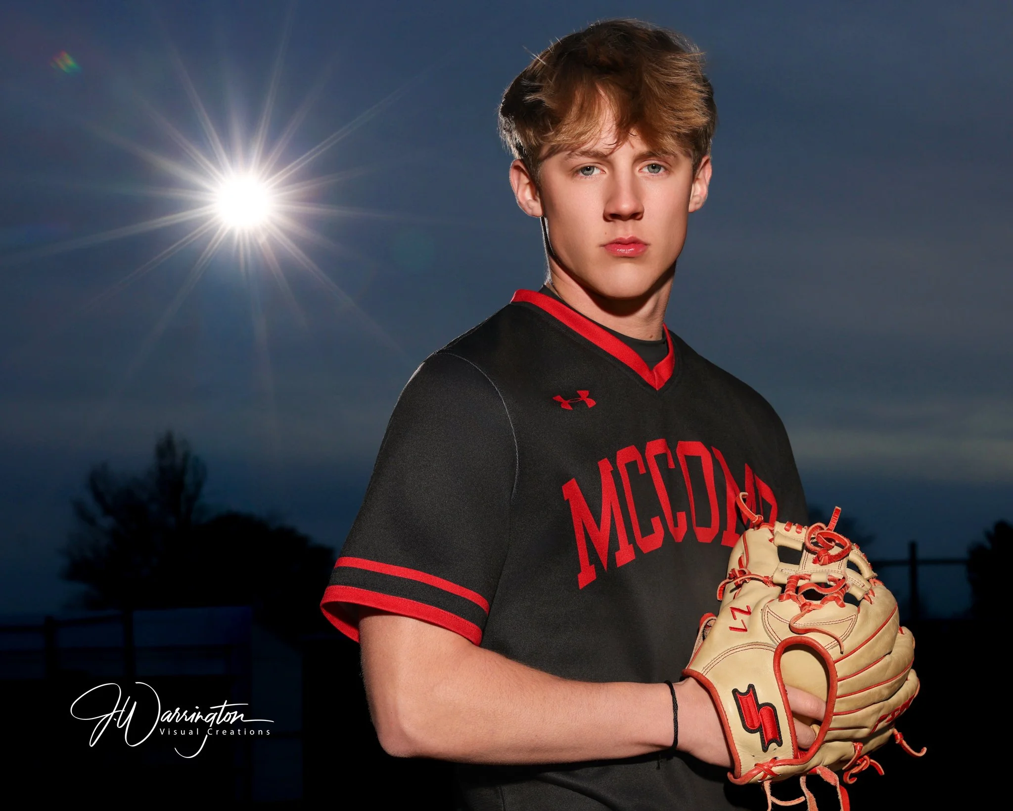 McComb High School senior boy baseball player posing in his team uniform while holding a baseball glove