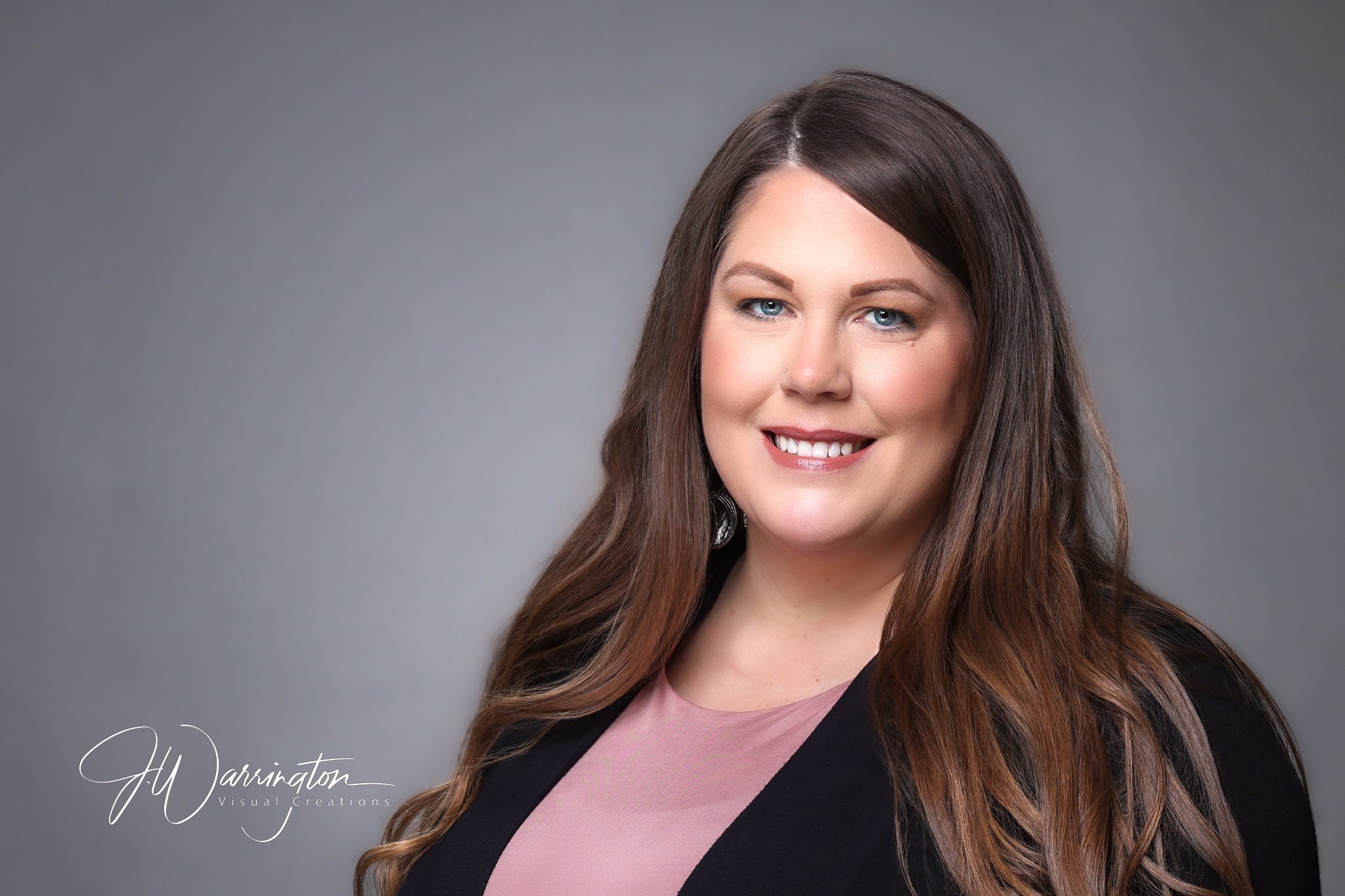 Smiling woman wearing pink blouse black blazer professional headshot by northwest ohio photographer