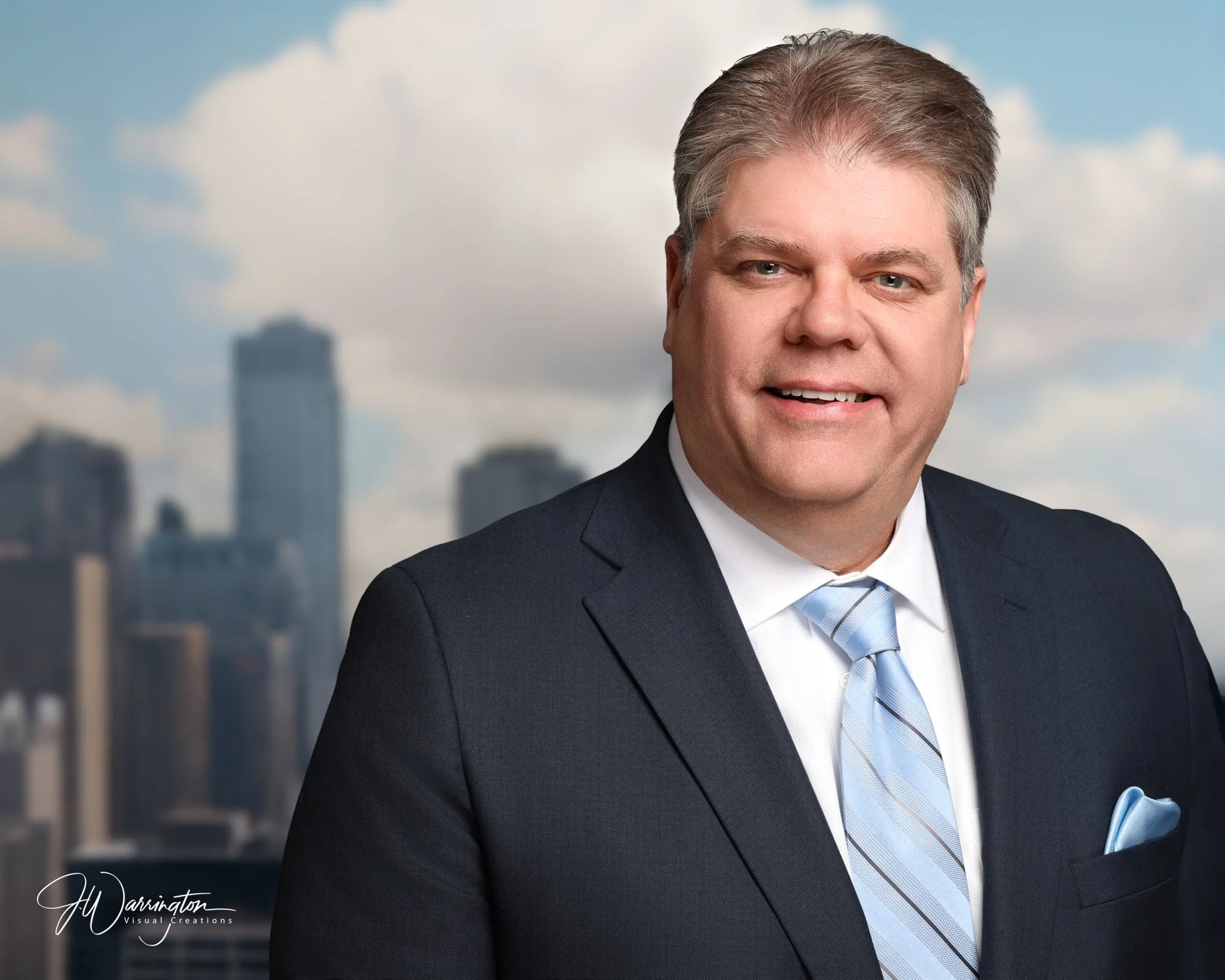 Smiling man in a white shirt and dark blazer, studio portrait by northwest ohio photographer