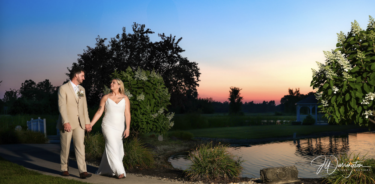 Stunning sunset bride and groom photography walking along water looking at each other by Findlay photographer