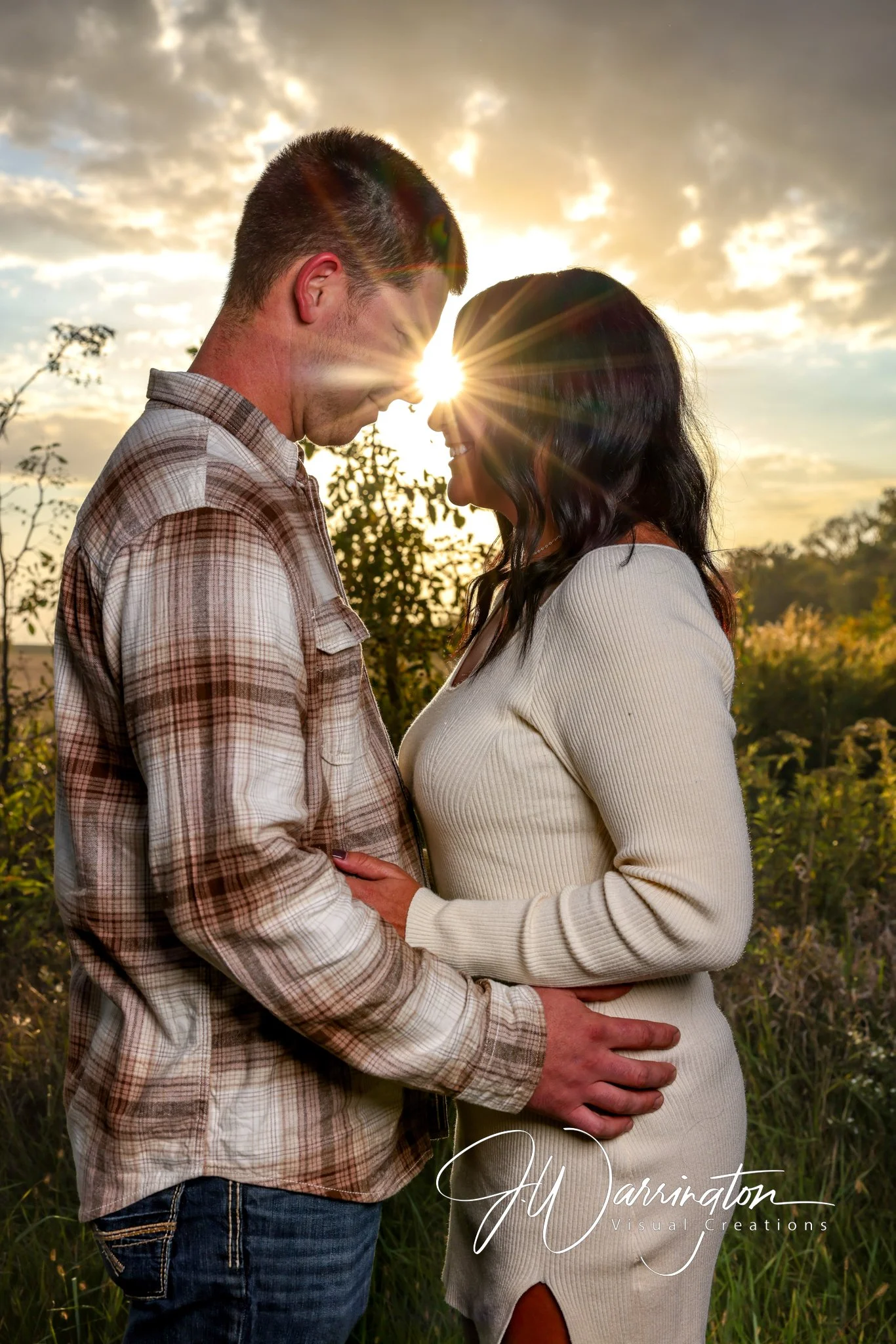 Engaged couple outdoor field during a romantic golden hour sunset engagement portrait session by northwest ohio photographer