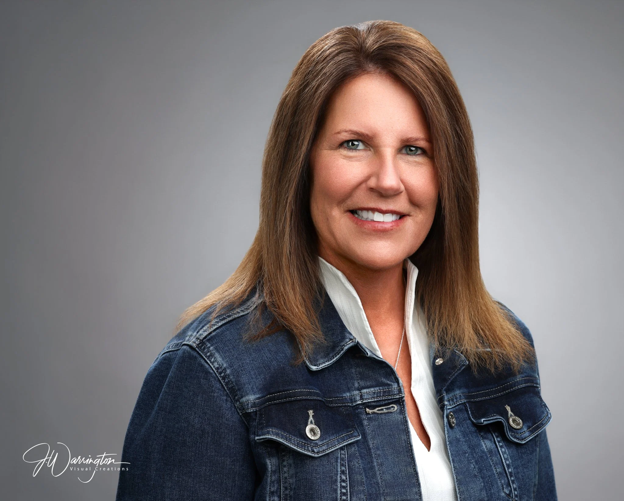 Smiling woman wearing denim jacket and white blouse professional headshot by northwest ohio photographer