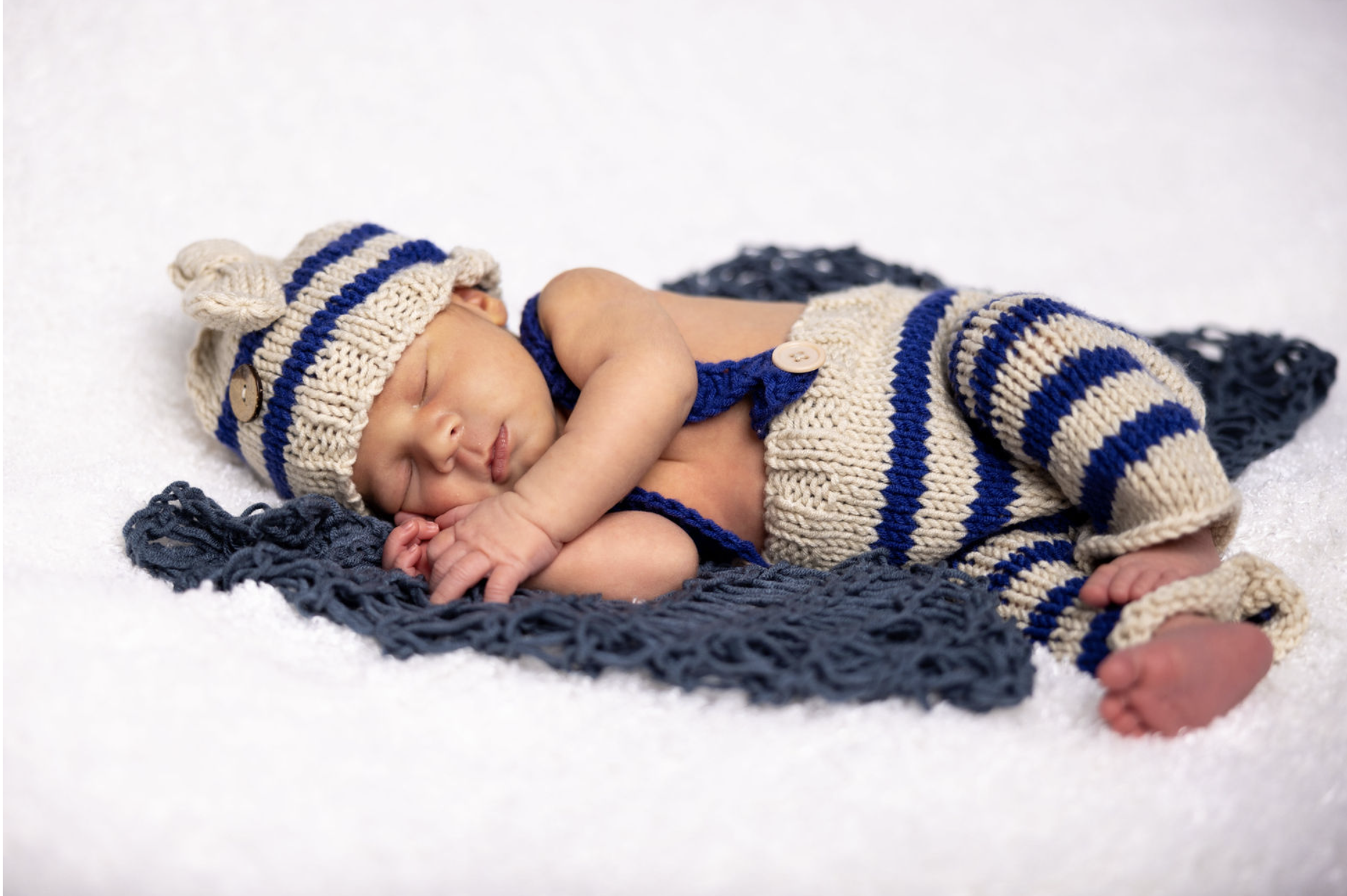 Sleeping baby wearing blue stripes