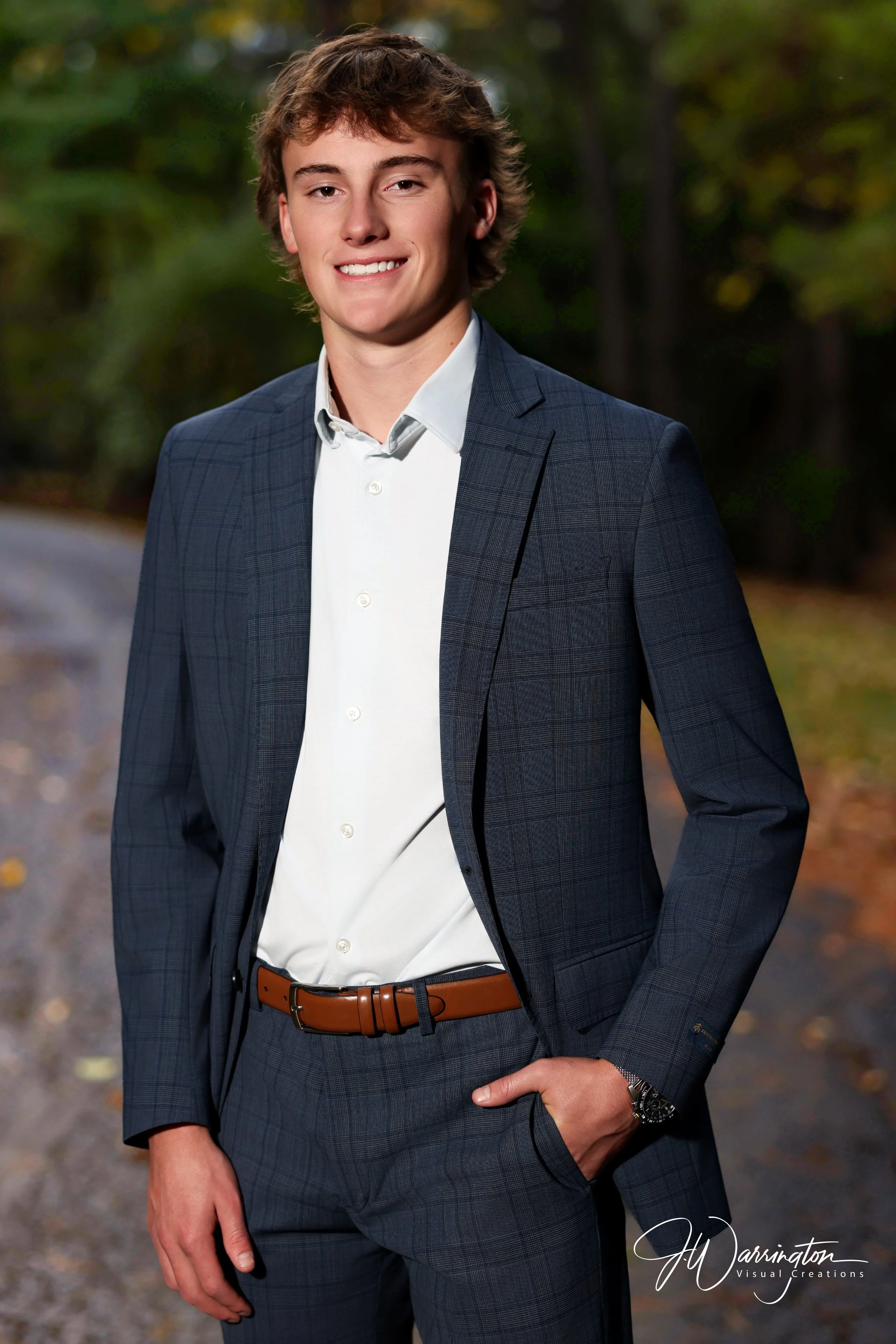 Male senior smiling, wearing a blue blazer.