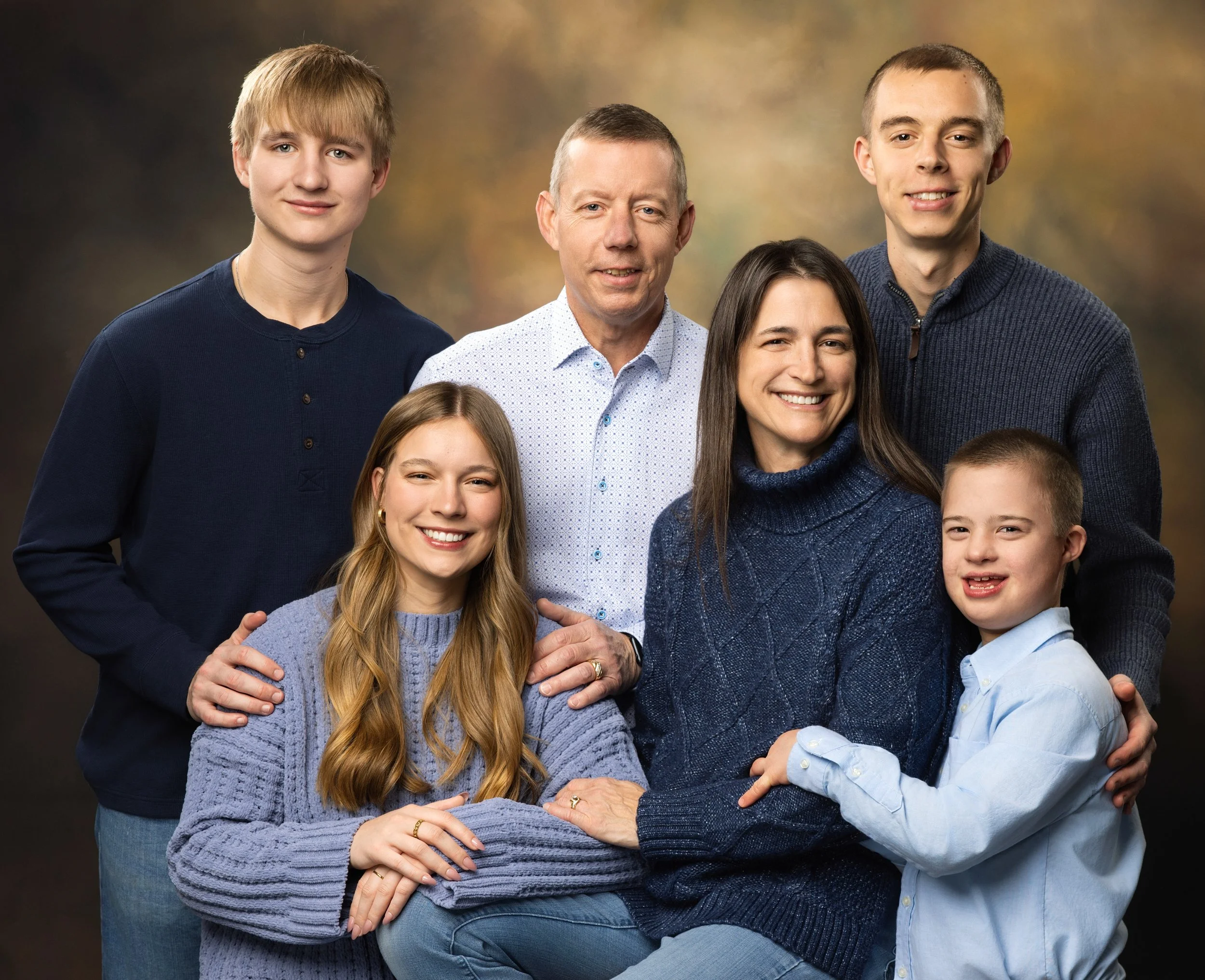 Big family photos with tan backdrop and navy and blue clothing by northwest ohio photographer