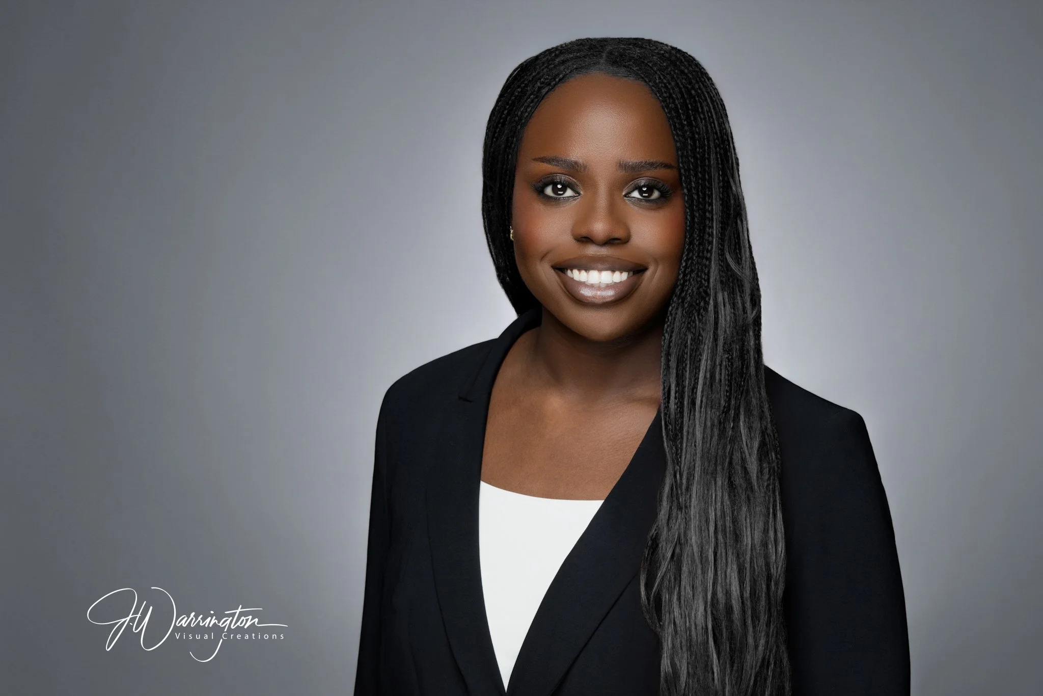 Professional corporate headshot of a smiling young businesswoman with long black hair by northwest ohio photographer 