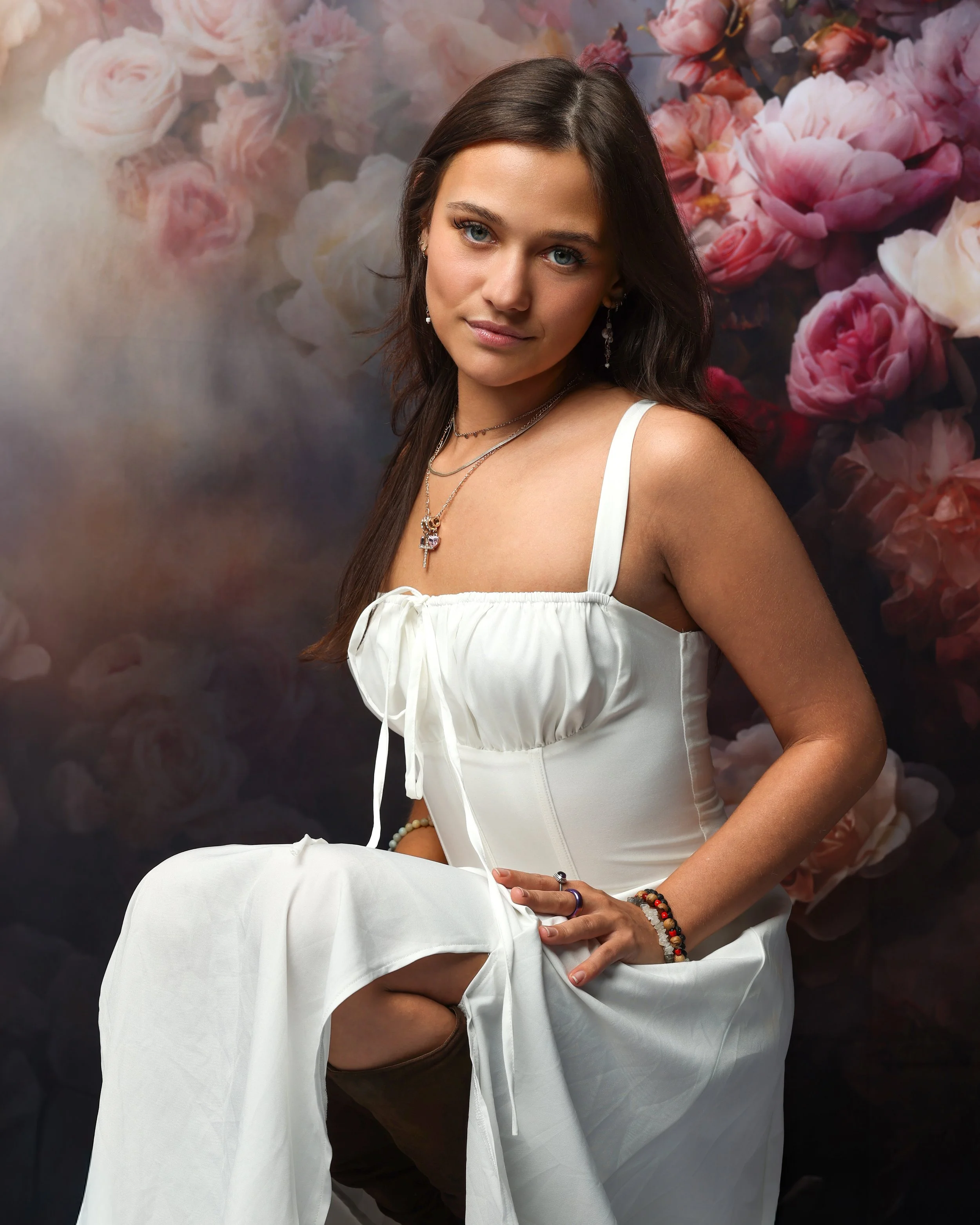 Studio portrait of a beautiful teenage girl behind a floral backdrop captured by northwest ohio photographer 