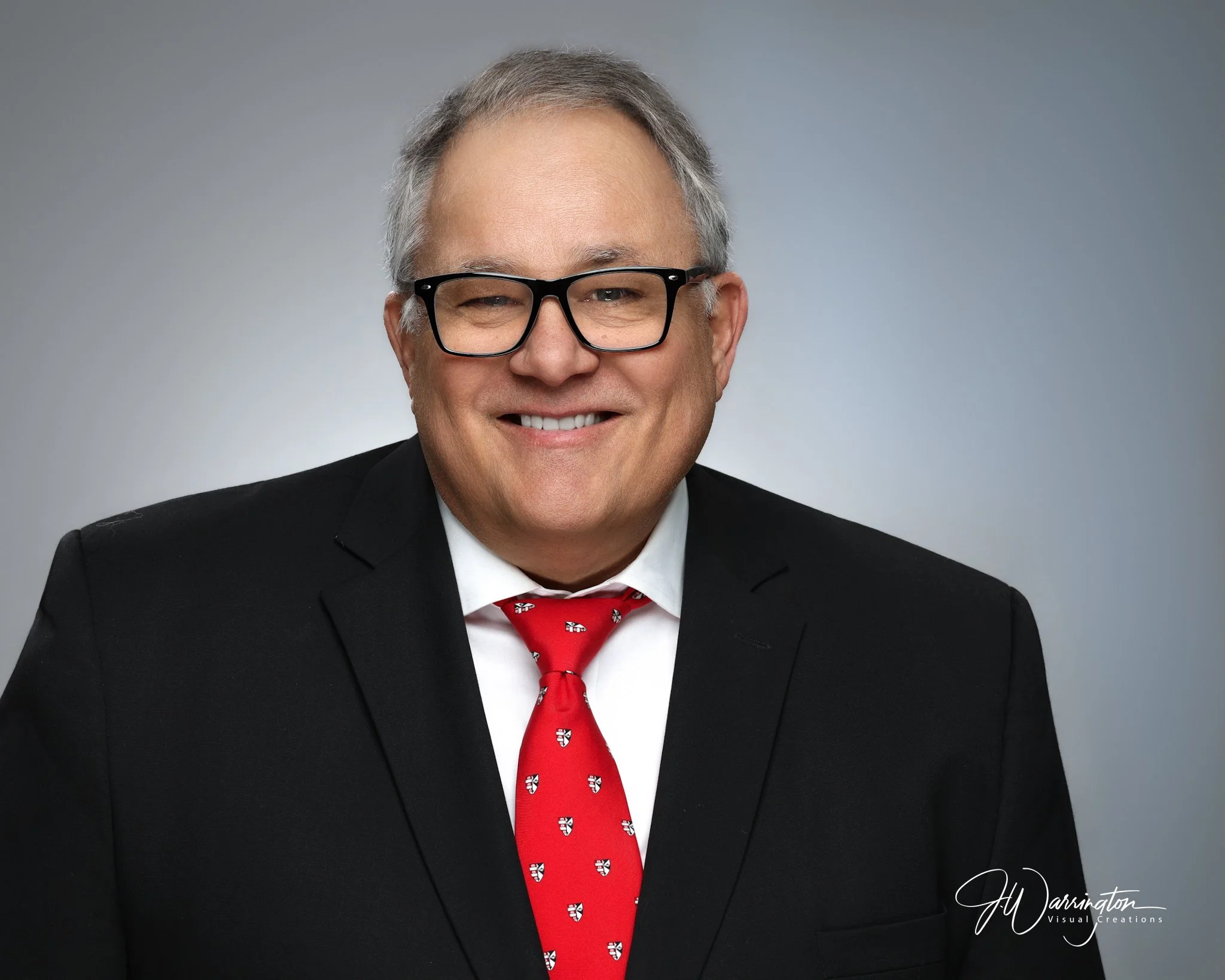 Smiling older man in a white shirt and dark blazer, studio portrait by northwest ohio photographer