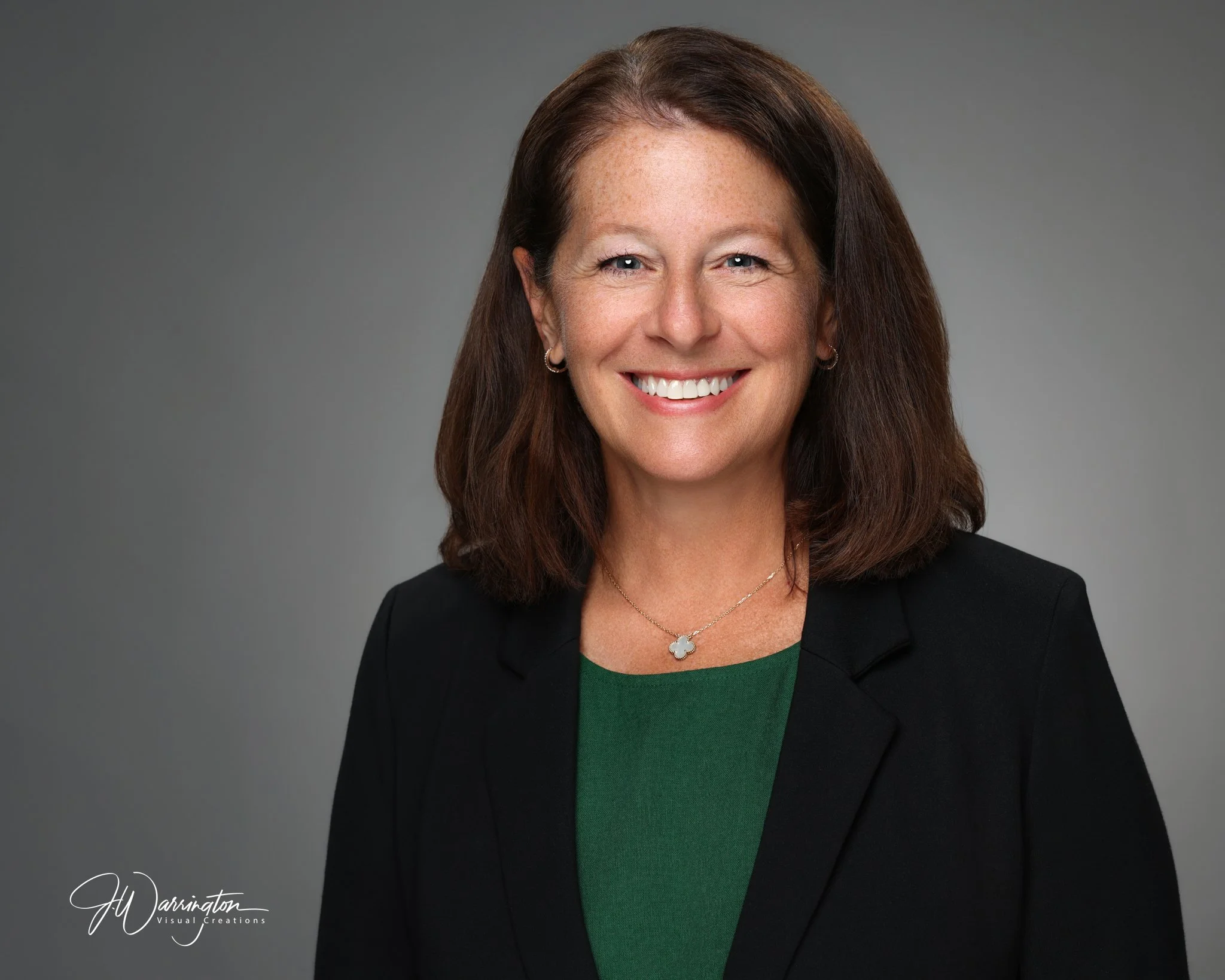 Female professional headshot gray background.