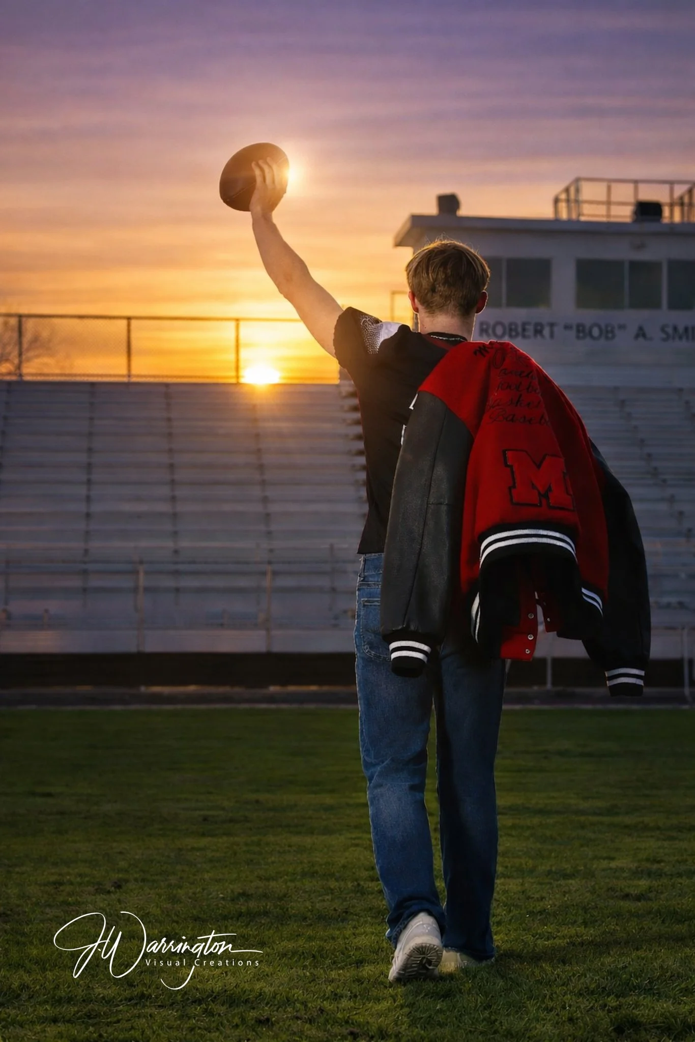 High school senior male walking towards the stadium lights during a sunset sports portrait session by Findlay Ohio photographer.