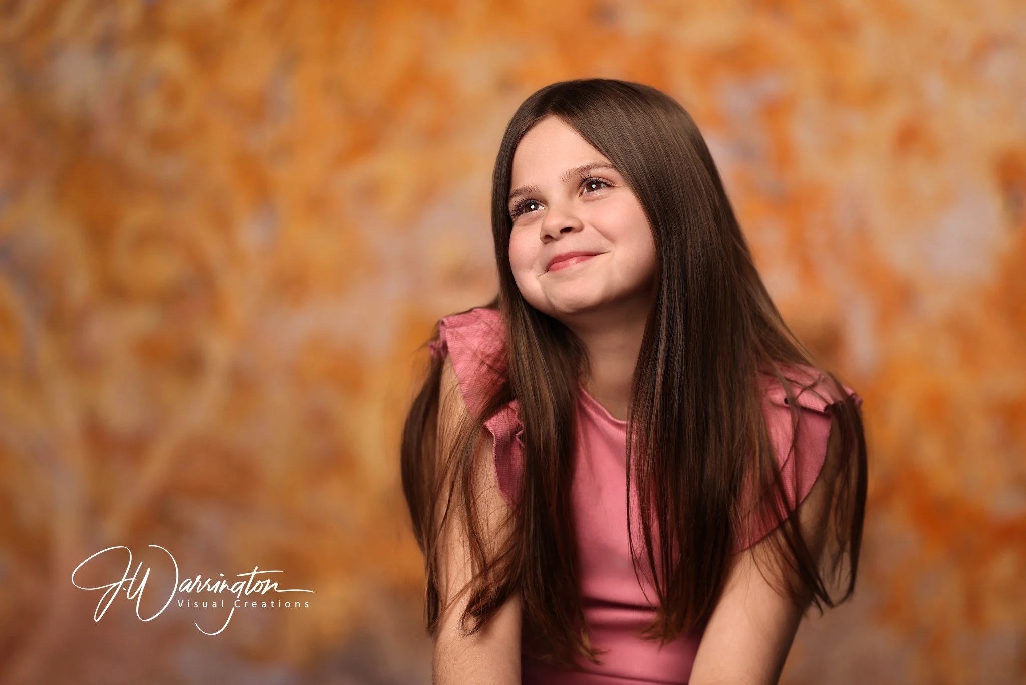 Sweet brown haired little girl with orange backdrop northwest ohio photographer