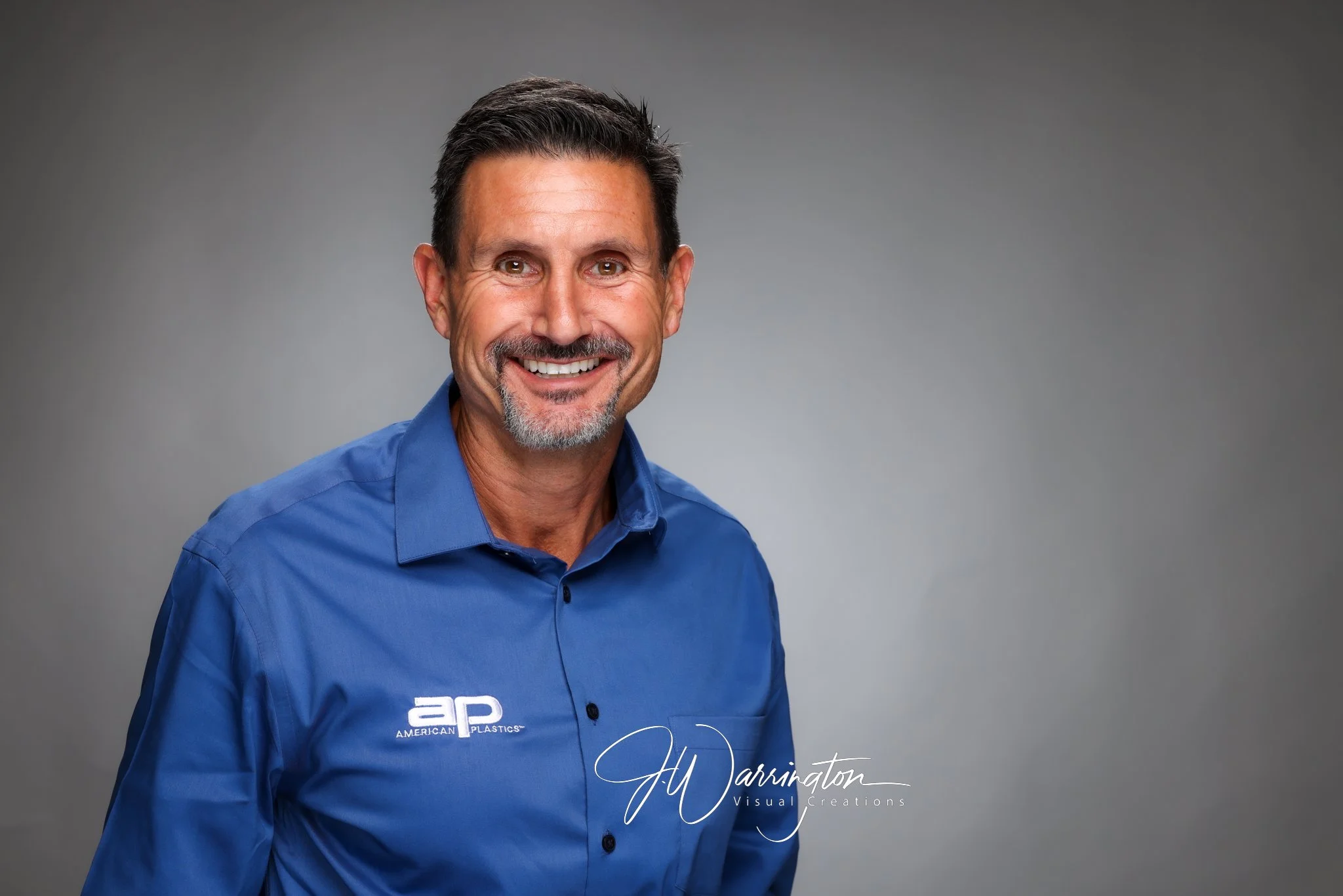 Professional corporate headshot of a smiling businessman wearing a royal blue button-down by northwest ohio photographer 