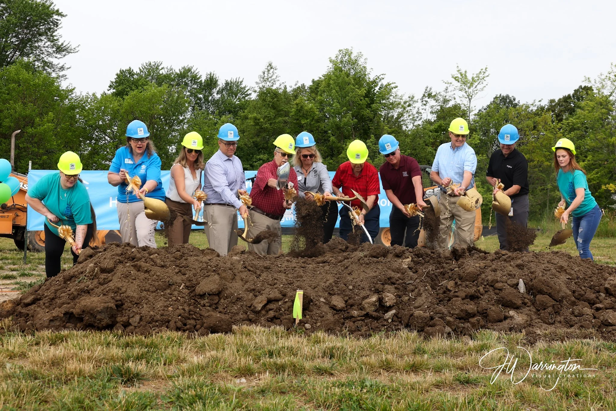 A group of local leaders and organizers participate in an outdoor groundbreaking ceremony captured by  Northwest Ohio photographer