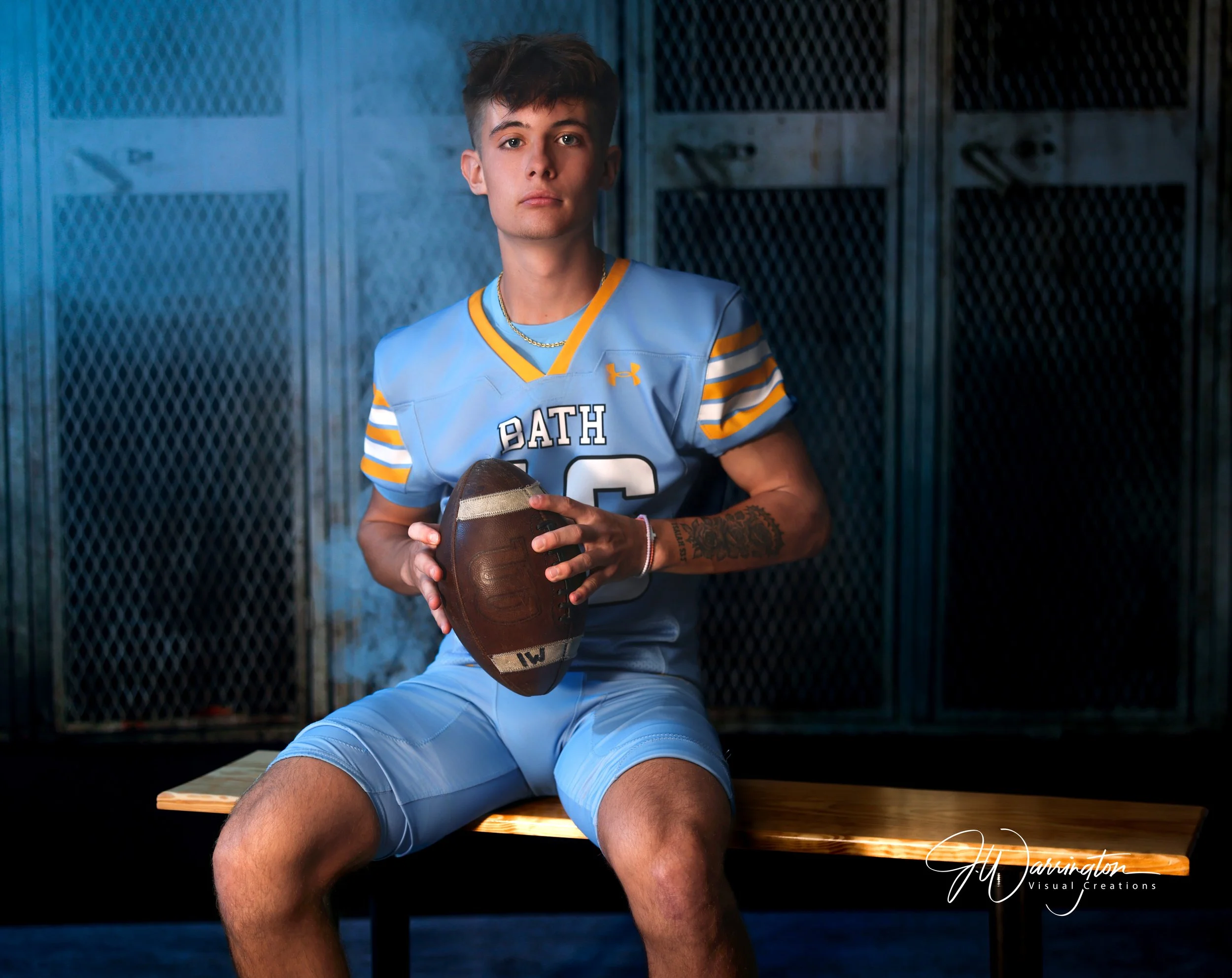 Make senior against a locker room backdrop with smoke and blue light.
