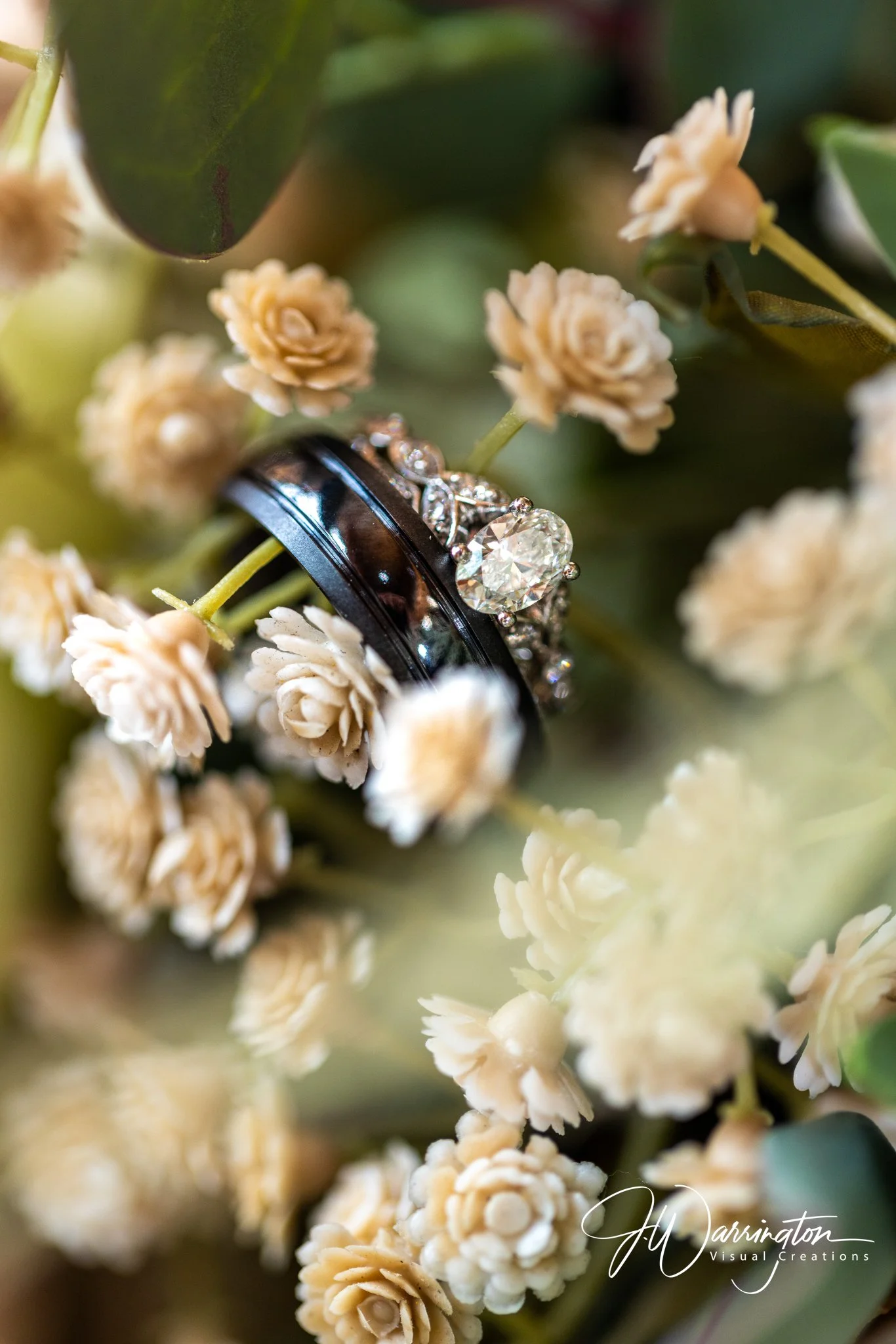 Detail shot of the groom's wedding band placed inside a bouquet of white baby's breath flowers, captured by northwest ohio photographer 