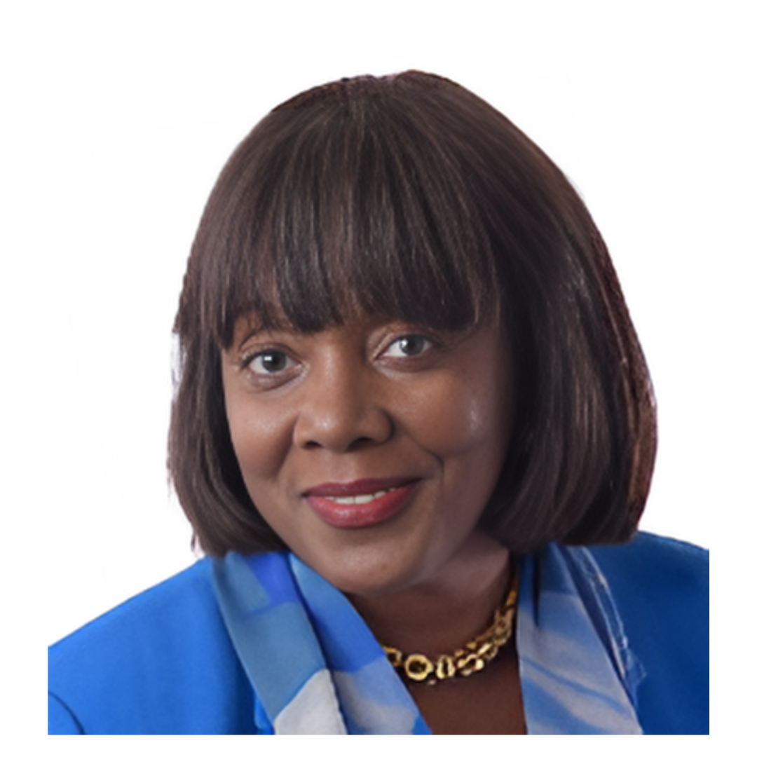 Portrait of a woman with dark hair and bangs, wearing a blue top and a gold necklace, smiling at the camera