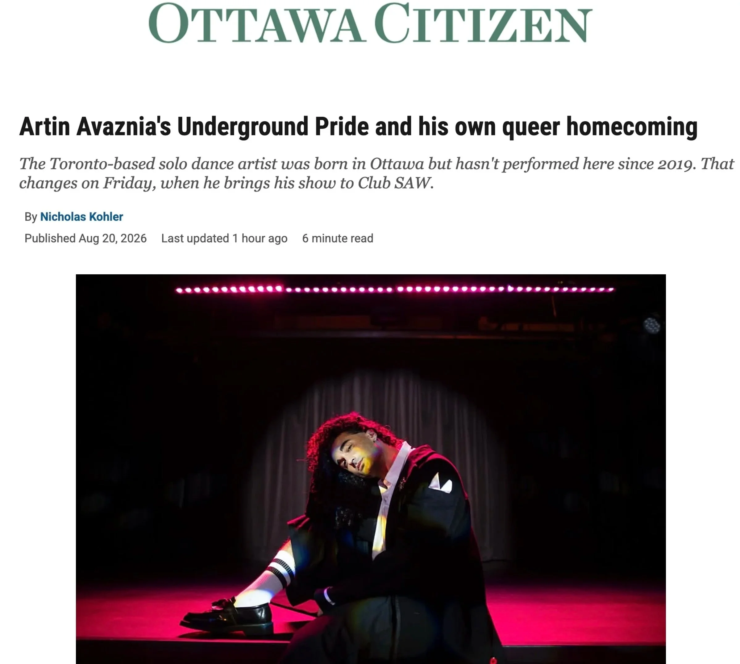 A performer with makeup, colorful hair, and queer pride attire, kneeling on stage with a pink-lit background, under a sign that reads 'Ottawa Citizen.'