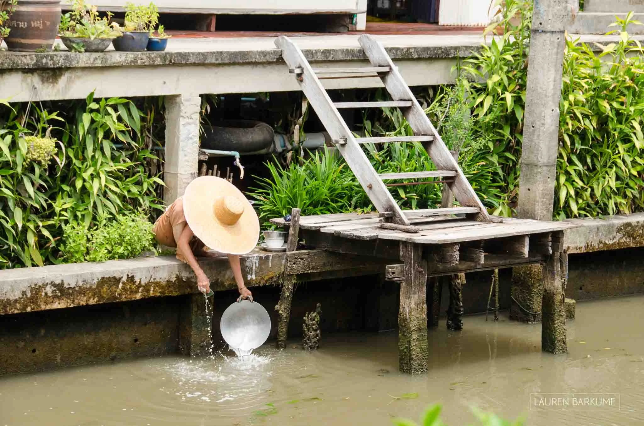 We caught this agile old lady quite by mistake while wandering along the decks of the stilted homes of the Damnoen Saduak floating market. She was doing the dishes, it was just past lunch time.
