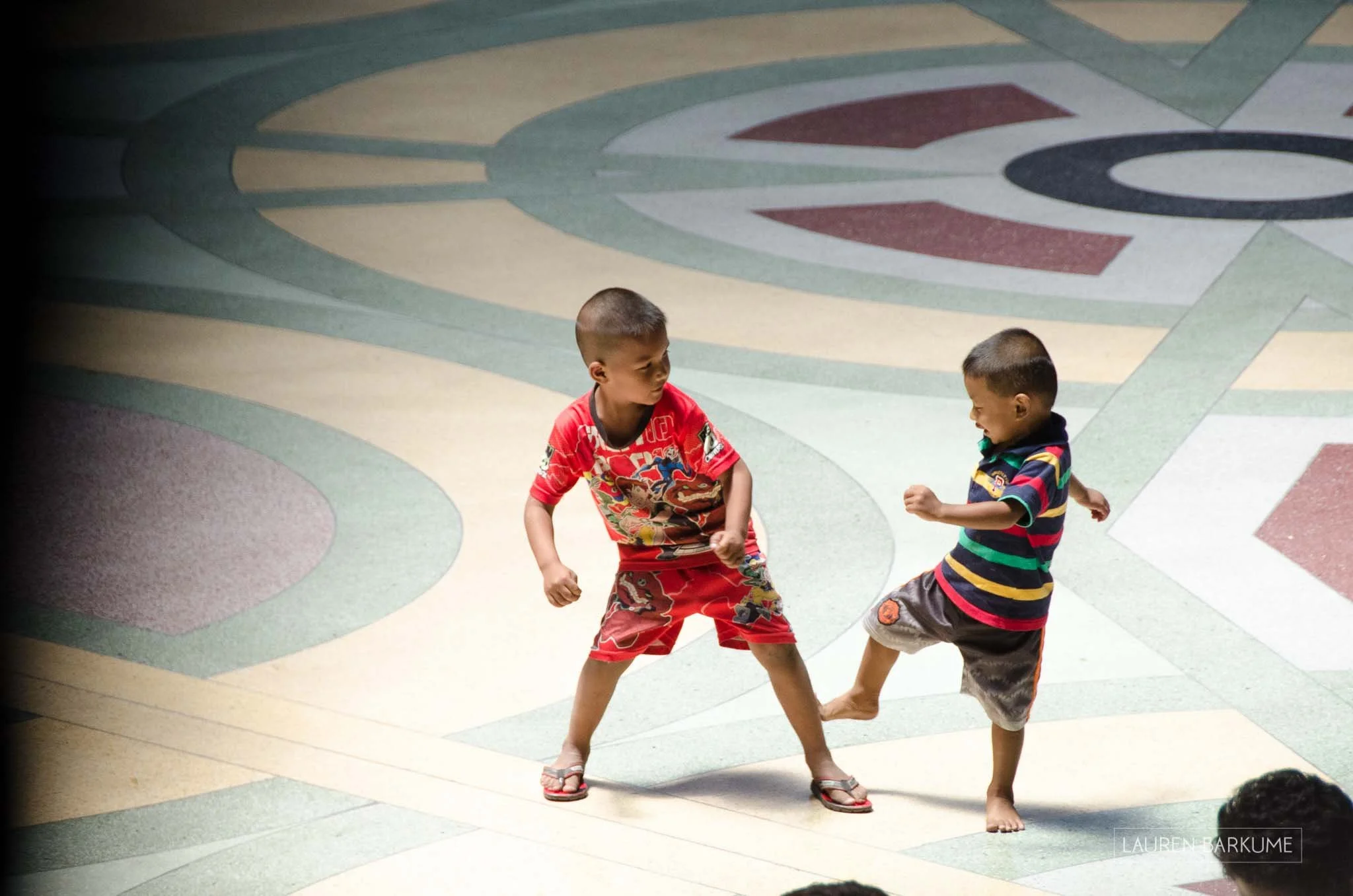 These little boys were waiting with their parents to take the train from Bangkok’s beautiful old fashioned train station to somewhere. Killing time, they roared around and fell into bouts of play Muay Thai boxing.