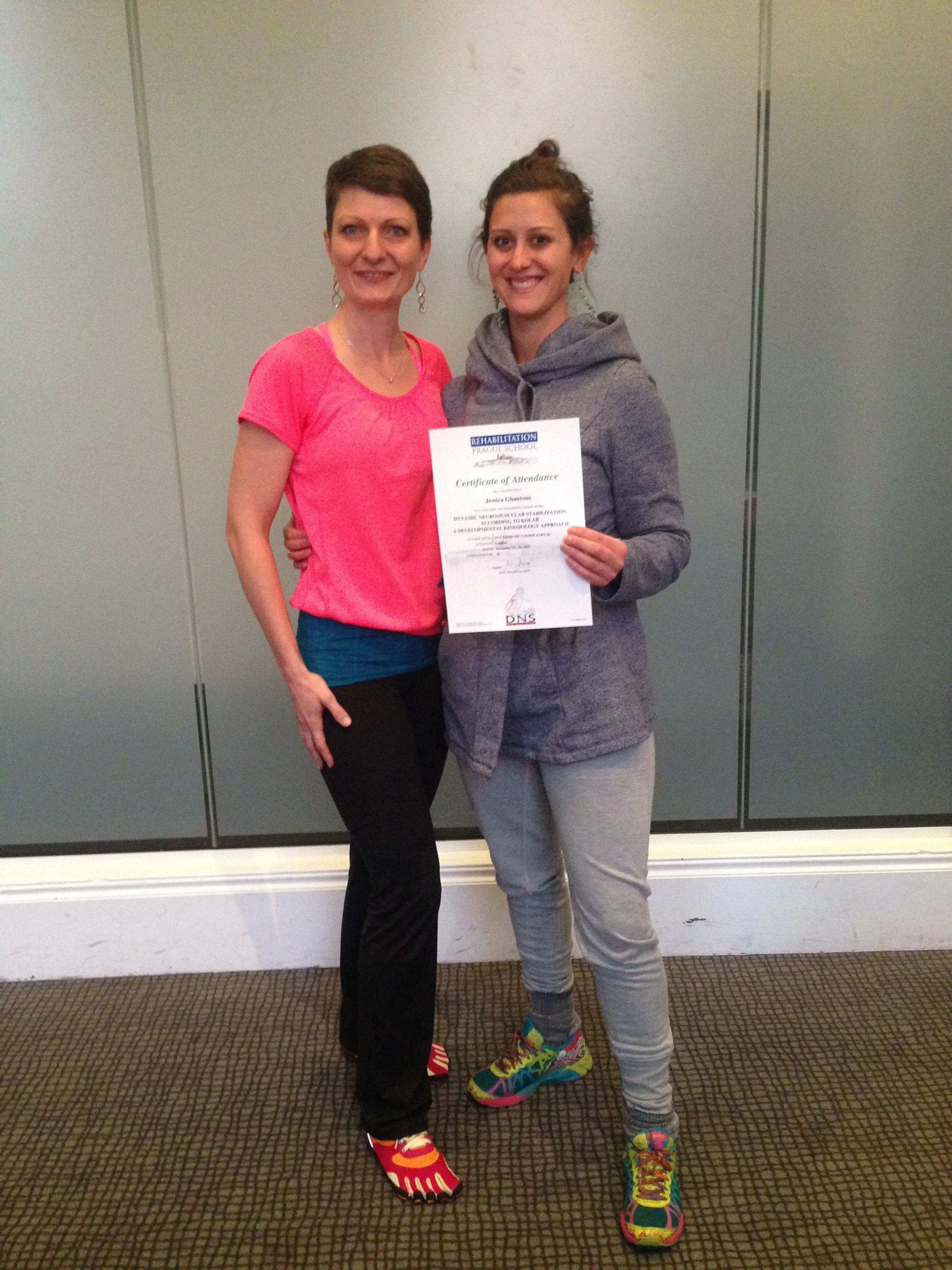 Image of Jessica Ghantous with colleague, and she's holding certificate from Rehabilitation Prague School.