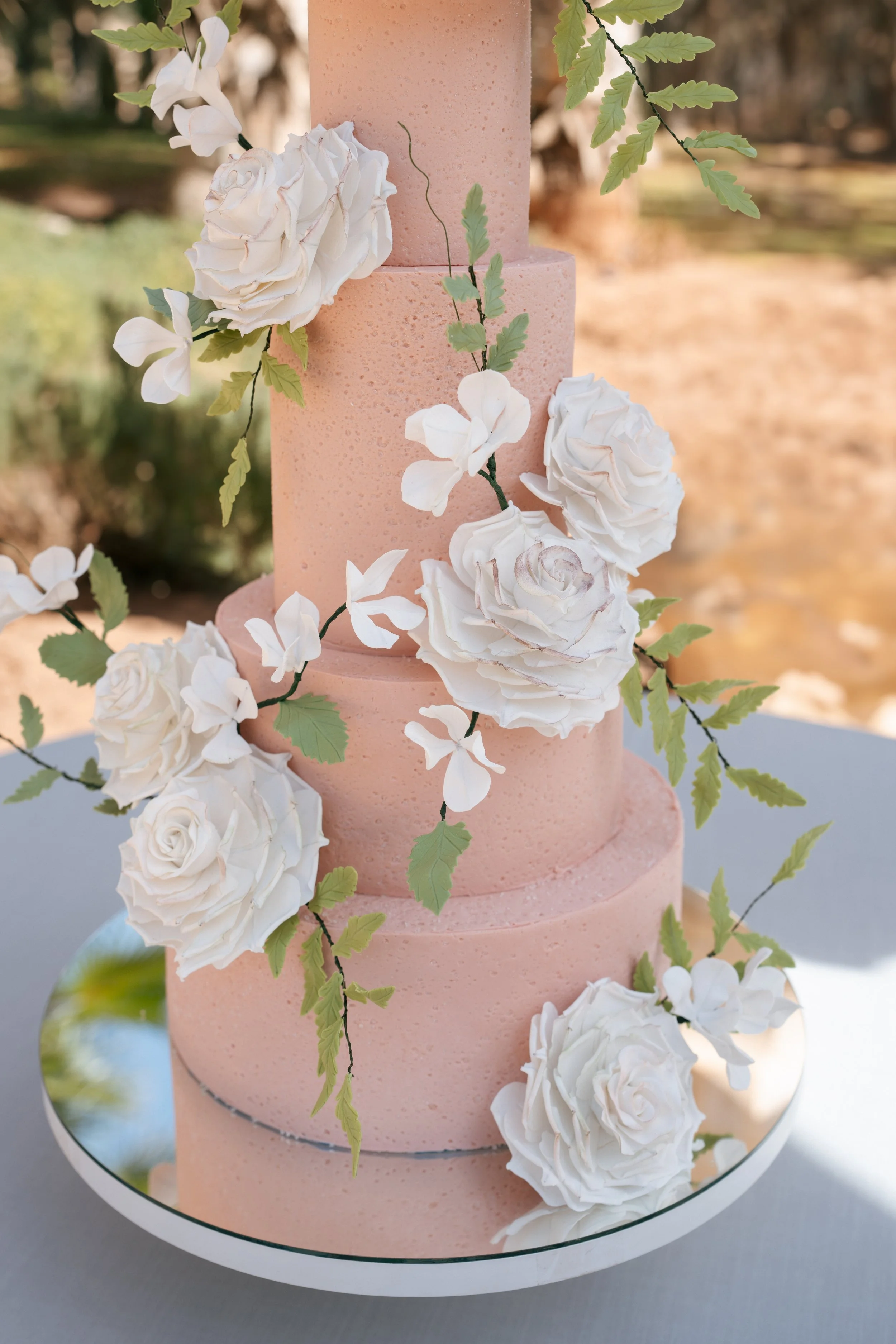 pink wedding cake with flowers