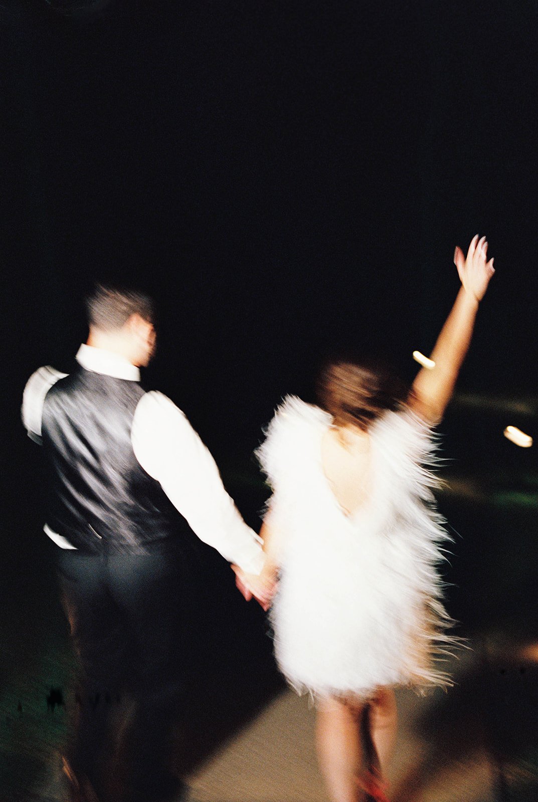 Couple Walking Into Tented Wedding Reception