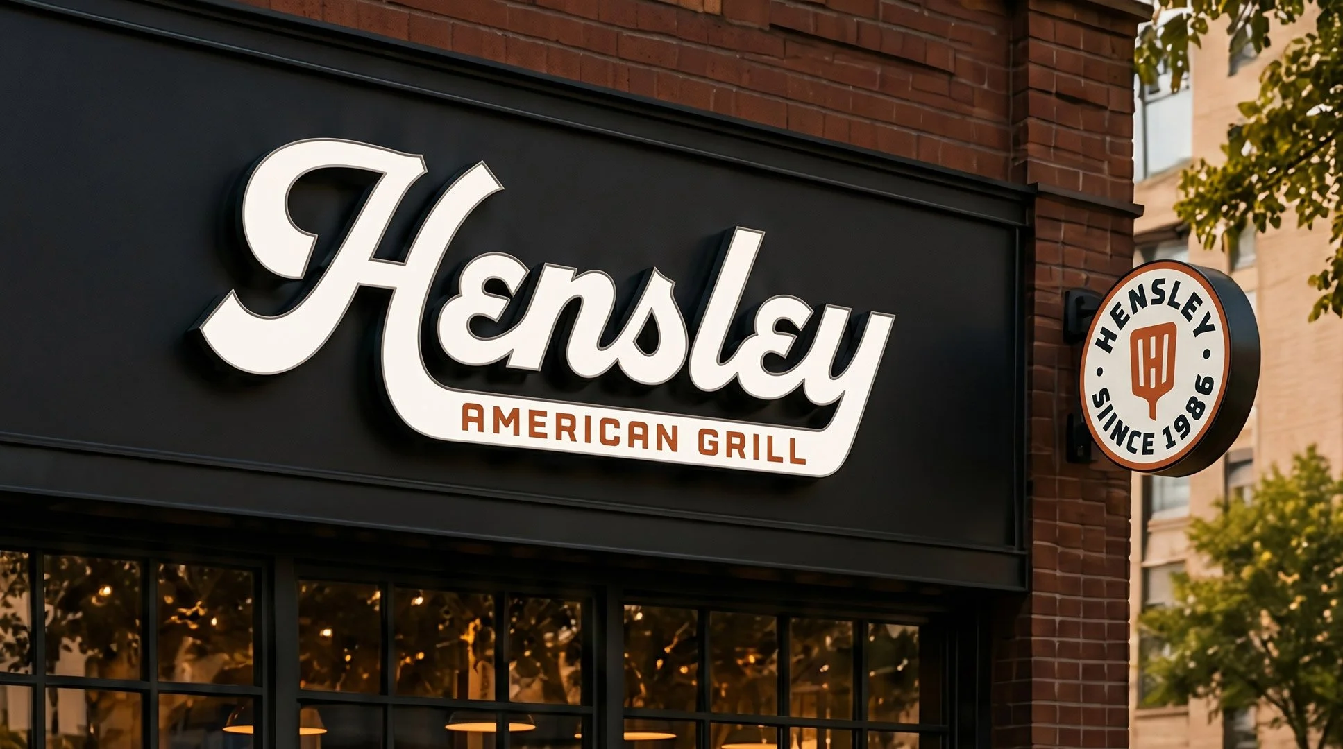 Hensley American Grill storefront signage with vintage-inspired script logo and round exterior badge sign.
