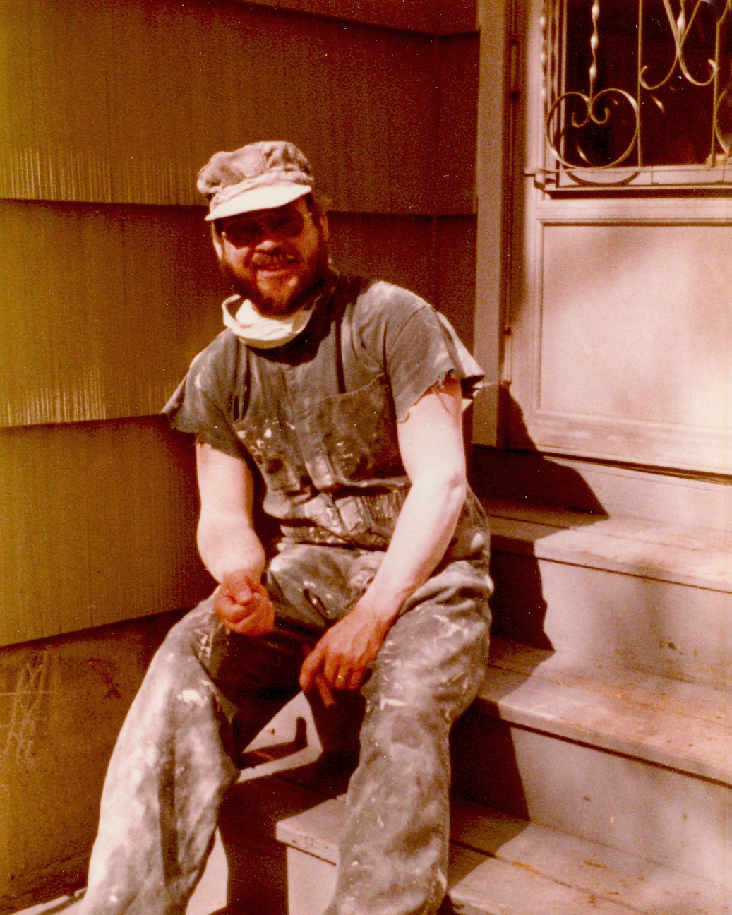 Dad staining the house, cigar in very stained hands!