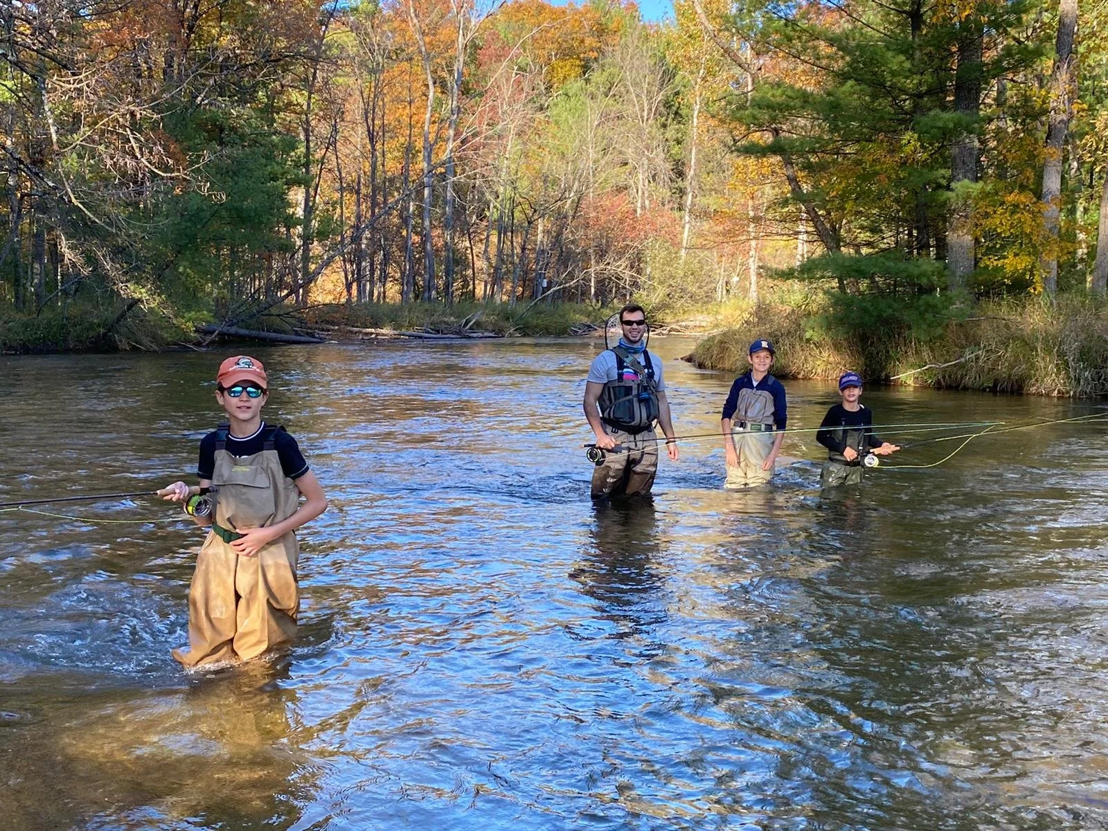 Kids enjoy outdoors and learn to fly fish with their family
