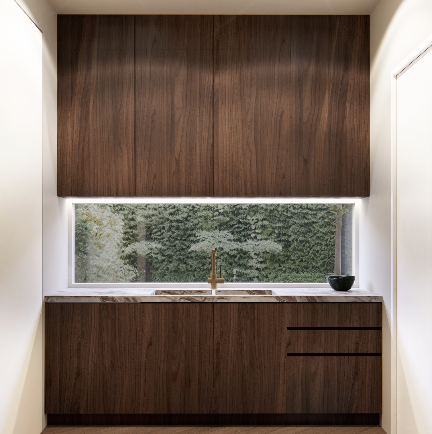 Modern kitchen with dark wood cabinets, a marble countertop, a brass faucet, a large horizontal window showing green trees outside, and a black bowl on the counter.