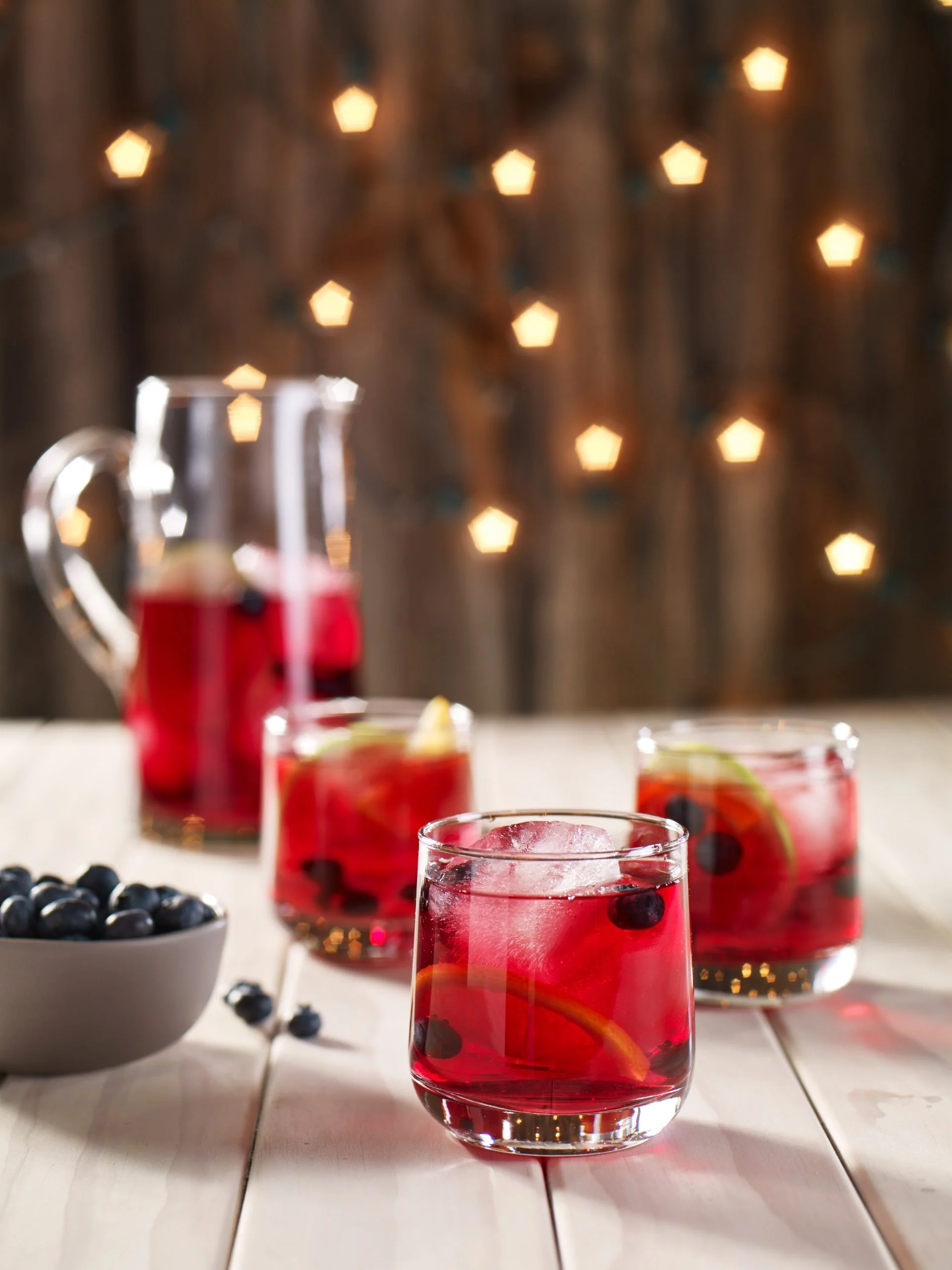 Jennie Jackson sitting in a vintage red truck with Ocean Spray logo on door