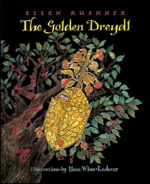 Book cover of 'The Golden Dreyddl' by Ellen Kushner, featuring a yellow creature with floral and leafy patterns hanging from a tree with green leaves and flowers.