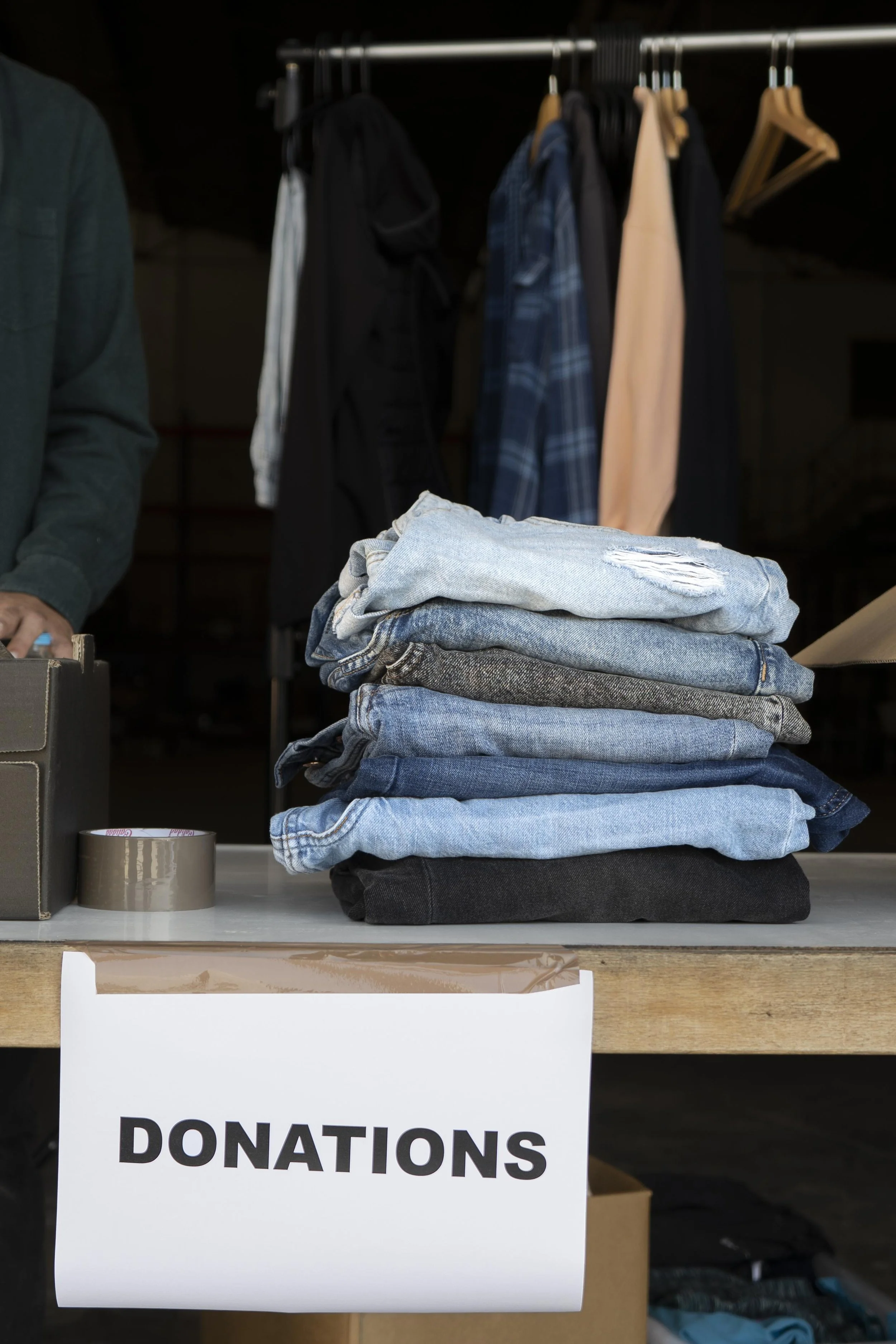 This is an image of folded jeans of different colors on a table.