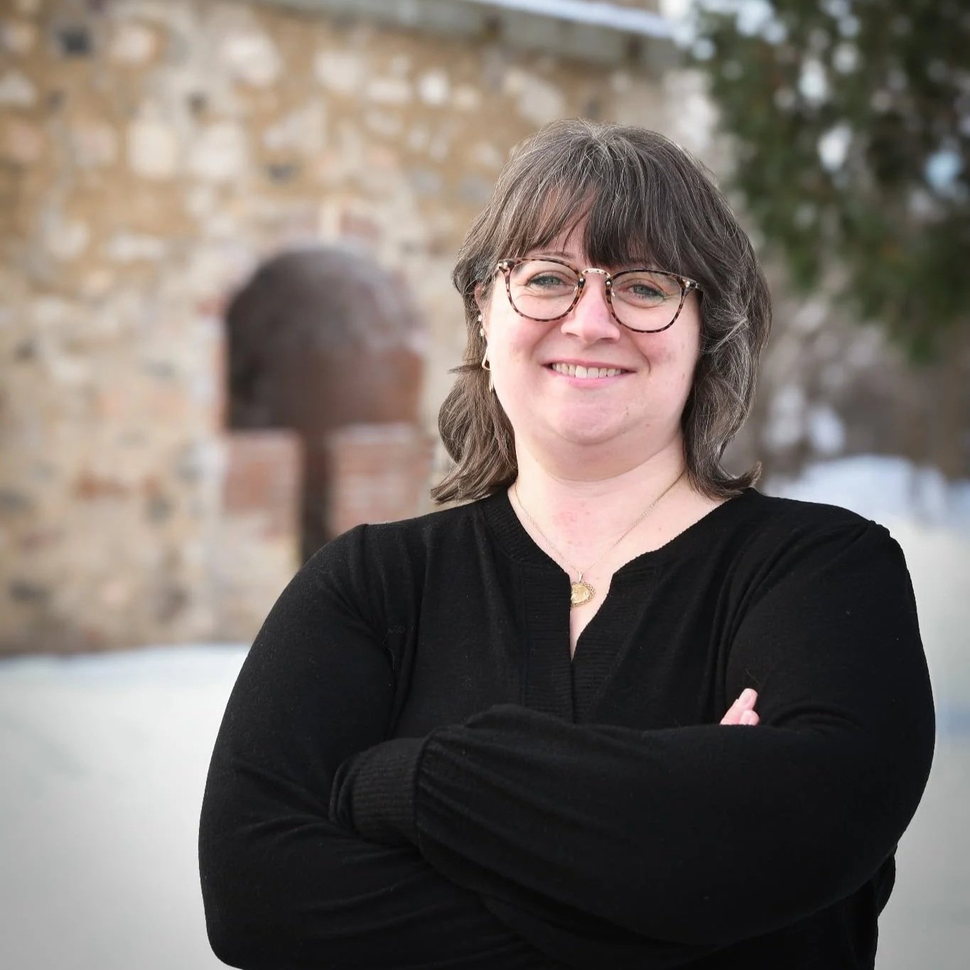 Melissa Custer stands in front of lime kilns..