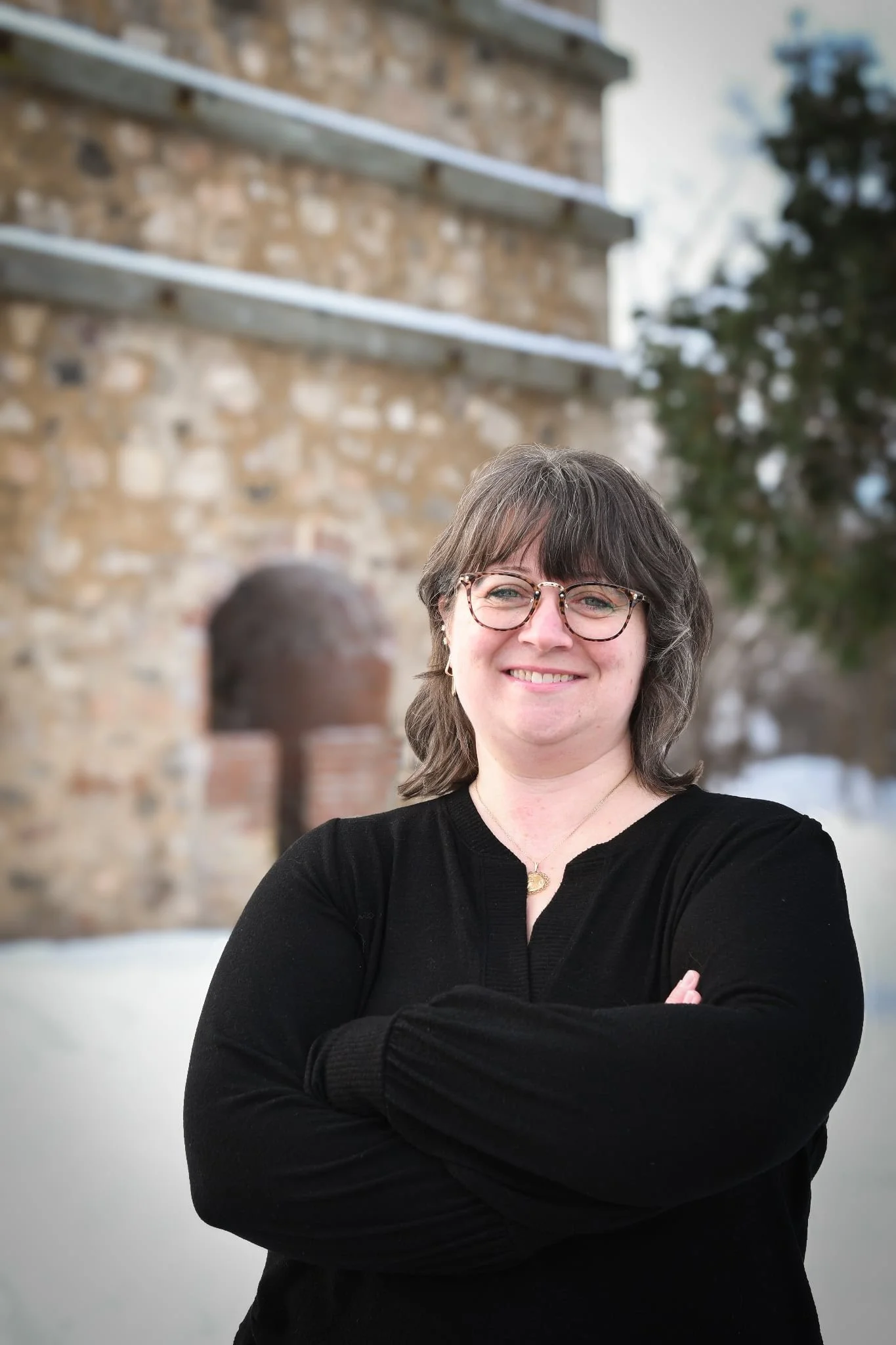 Melissa Custer stands in front of lime kilns..