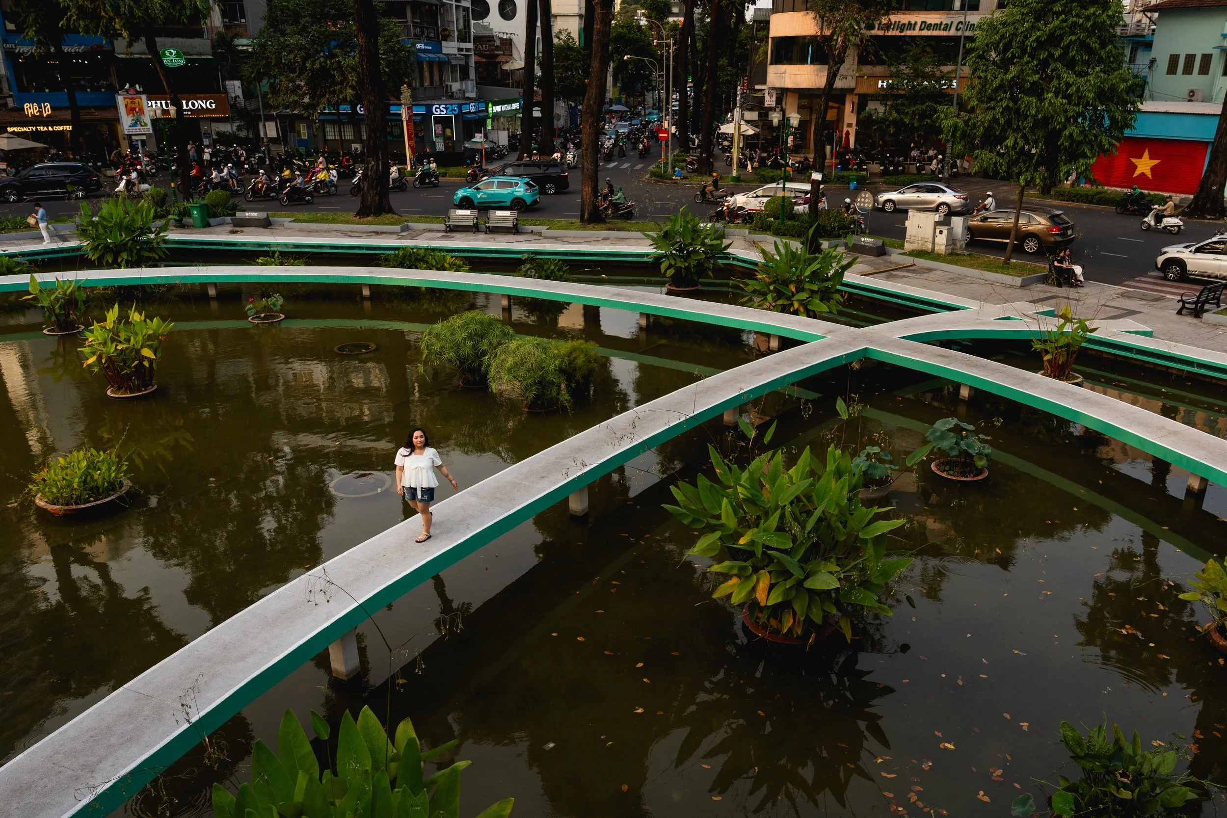 A woman walks around Turtle Lake in Saigon, Vietnam.