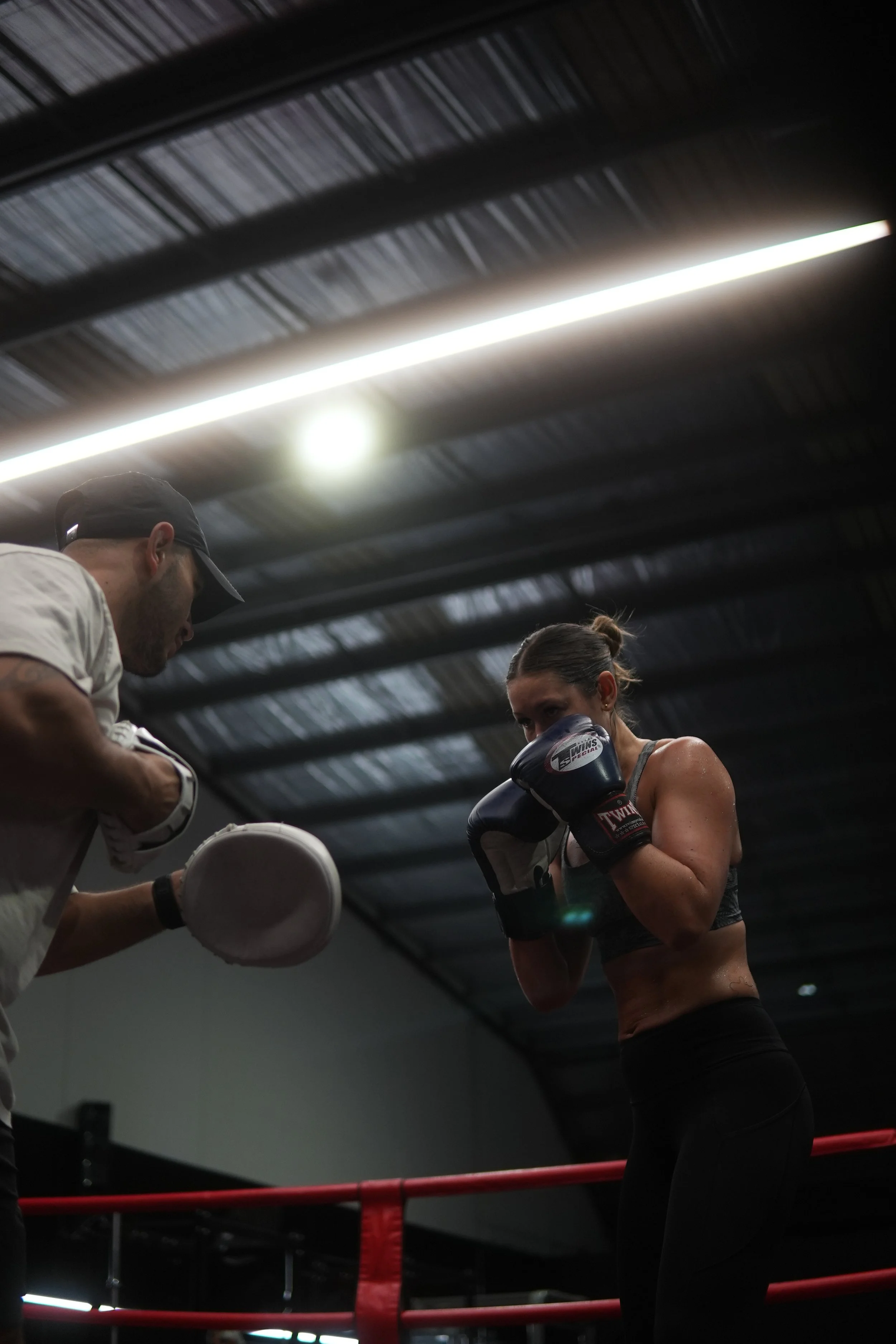 Coach holding pads during a boxing class at Millgate Boxing Bayside Melbourne