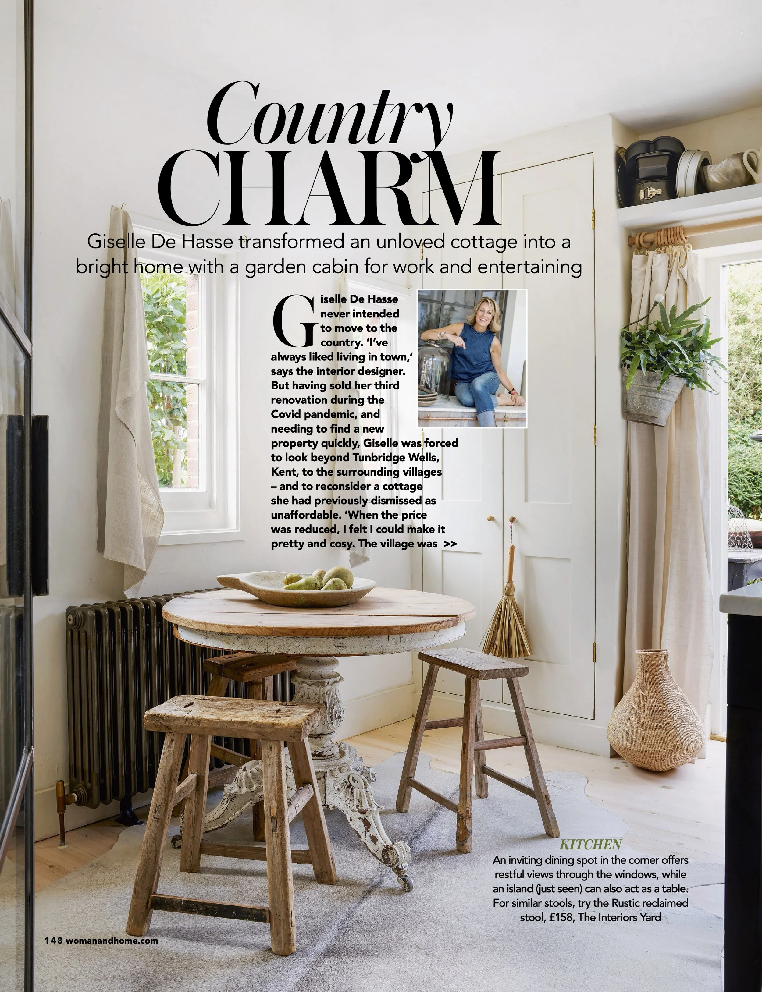 A kitchen with a rustic wooden table and stools, a cream-colored cabinet, potted plants, and sunlight coming through windows, with magazine text overlaying the scene.