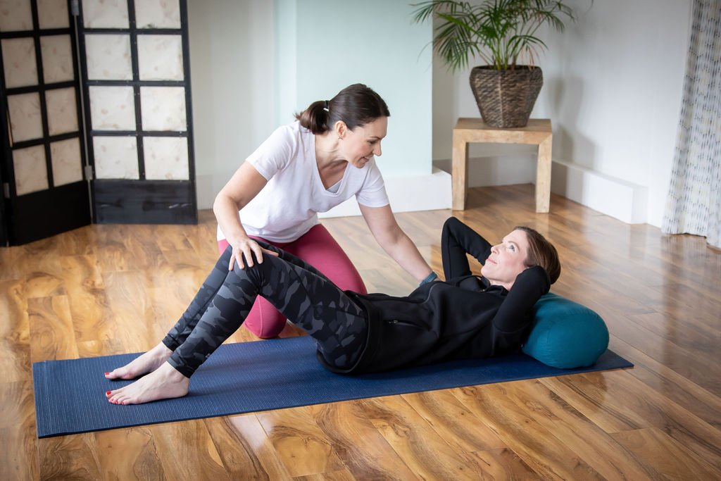 Physiotherapist treating lady lying on a mat.jpg