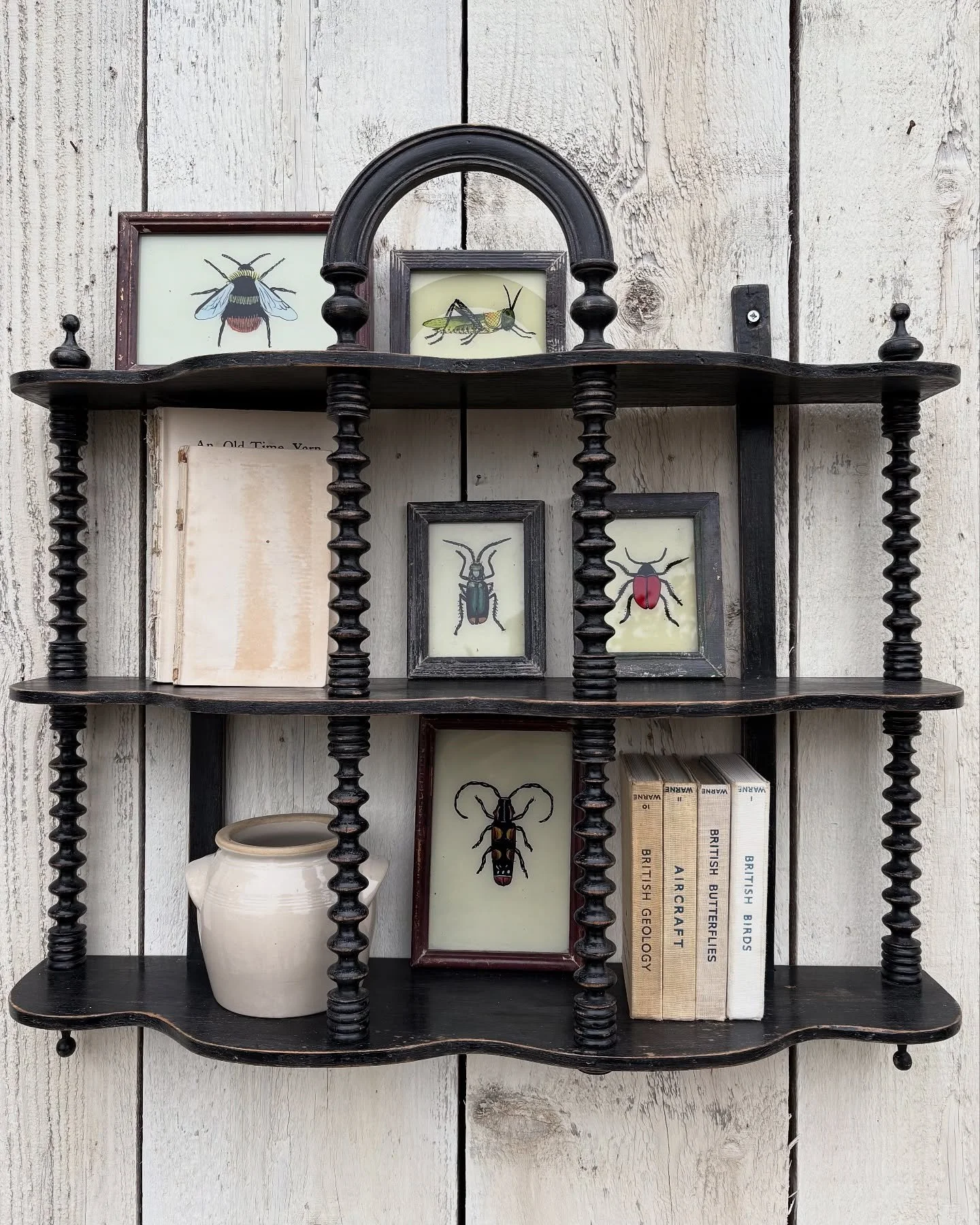 Very special French wall shelf with decorative bobbin detail. Solid condition in a distressed black paint finish. This will make a great addition to any room, adding a little bit of rustic chic. Fill it with your favourite trinkets and collectibles g
