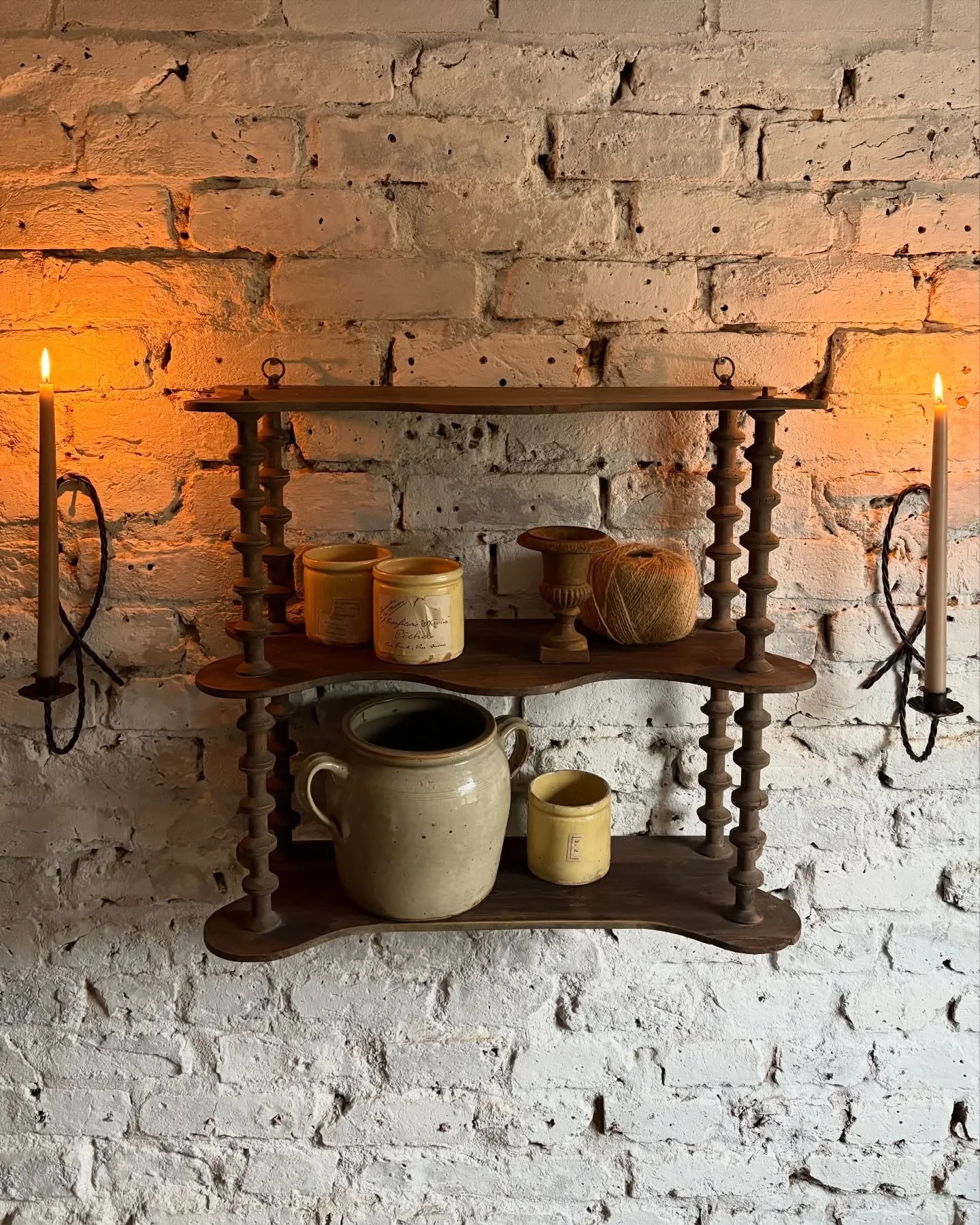 A wonderful cotton reel shelf featuring handmade pottery &amp; rope wall sconces with long tapered candles .. perfect for bringing warmth and comfort to your home during the darker winter months 🕯️ 
.
.
#simplehomestyle #decorativeantiques #rusticho