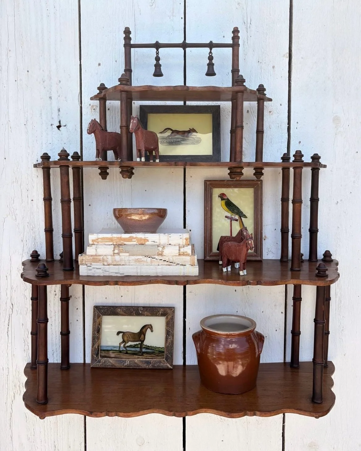 This wall shelf is full of vintage charm, featuring a timeless bamboo style design with beautifully turned spindle details, scalloped edges and a rich walnut finish. Our favourite feature has to be the two delicate hanging bells at the top, adding a 