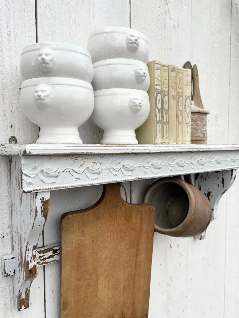A lovely little piece of French charm for the wall 🤍

This vintage oak wall shelf has the sweetest floral detail set in copper plate, framed by a beautifully distressed cool white painted finish.

The perfect size for a kitchen, bathroom or perhaps 