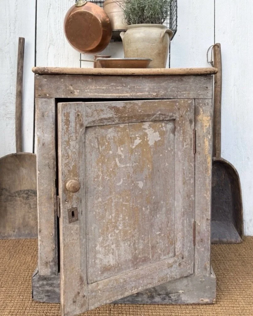 A handsome little French cupboard in the most wonderful moody greige.

Its paintwork tells the story of many lives and many layers, with soft taupes, weathered greys and warmer tones quietly revealing themselves beneath the surface.

It&rsquo;s a pie