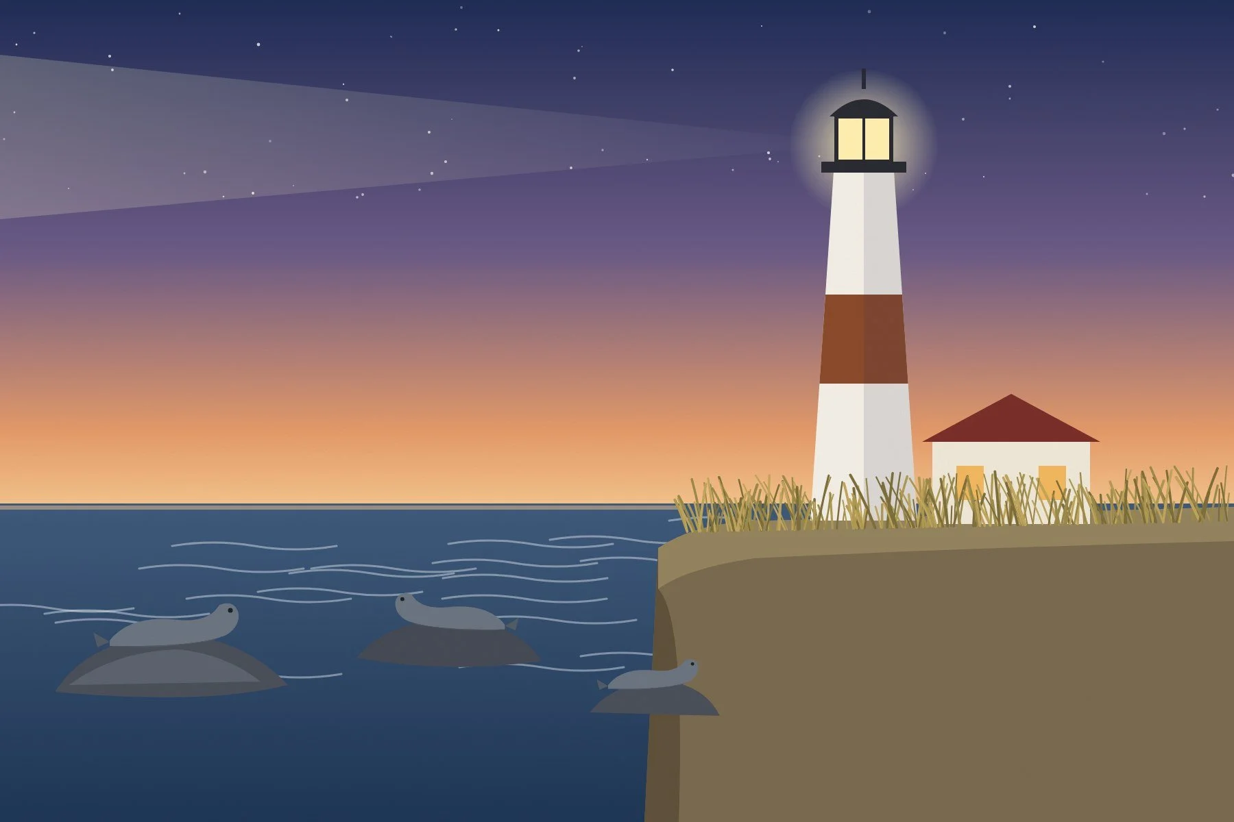 Montauk lighthouse glowing at dusk with seals resting on rocks offshore