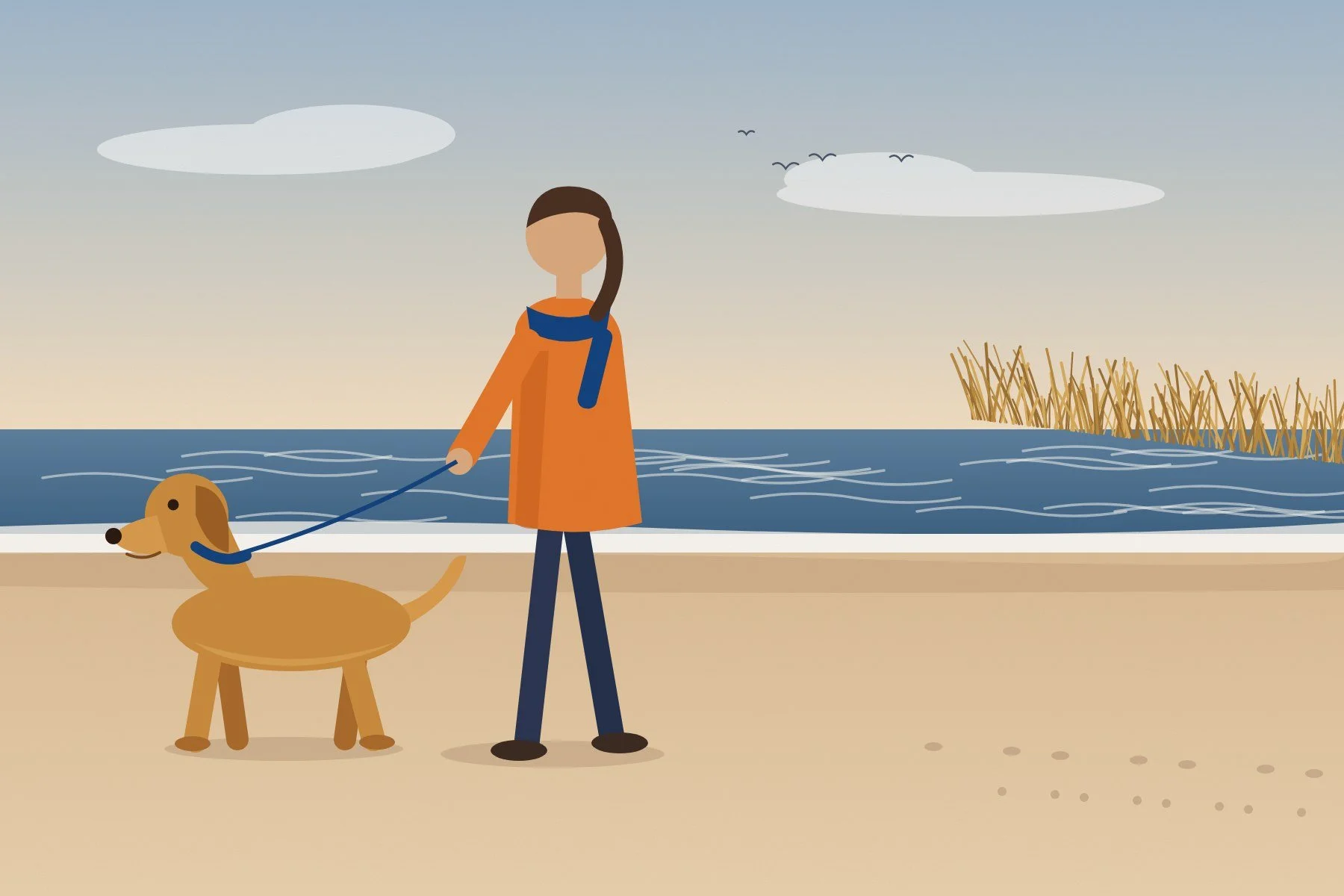 Woman in an orange coat walking a leashed dog on a quiet Hampton Bays beach in fall