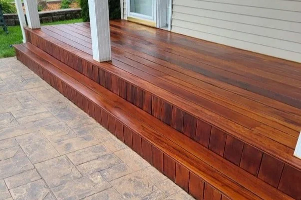 Wooden porch with stairs and stone patio