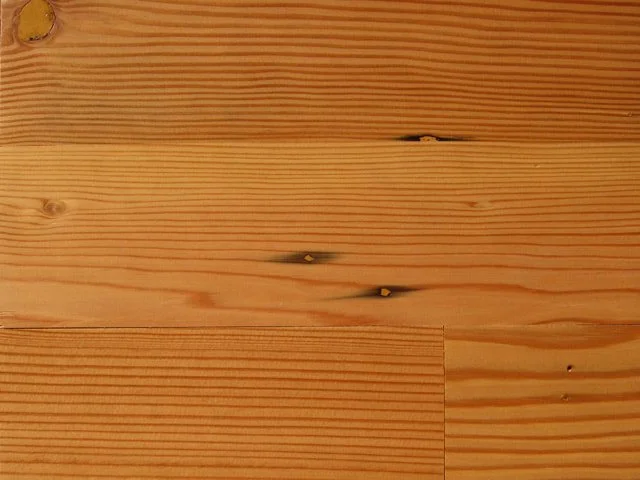 Close-up of wooden planks with visible grain patterns and knots.